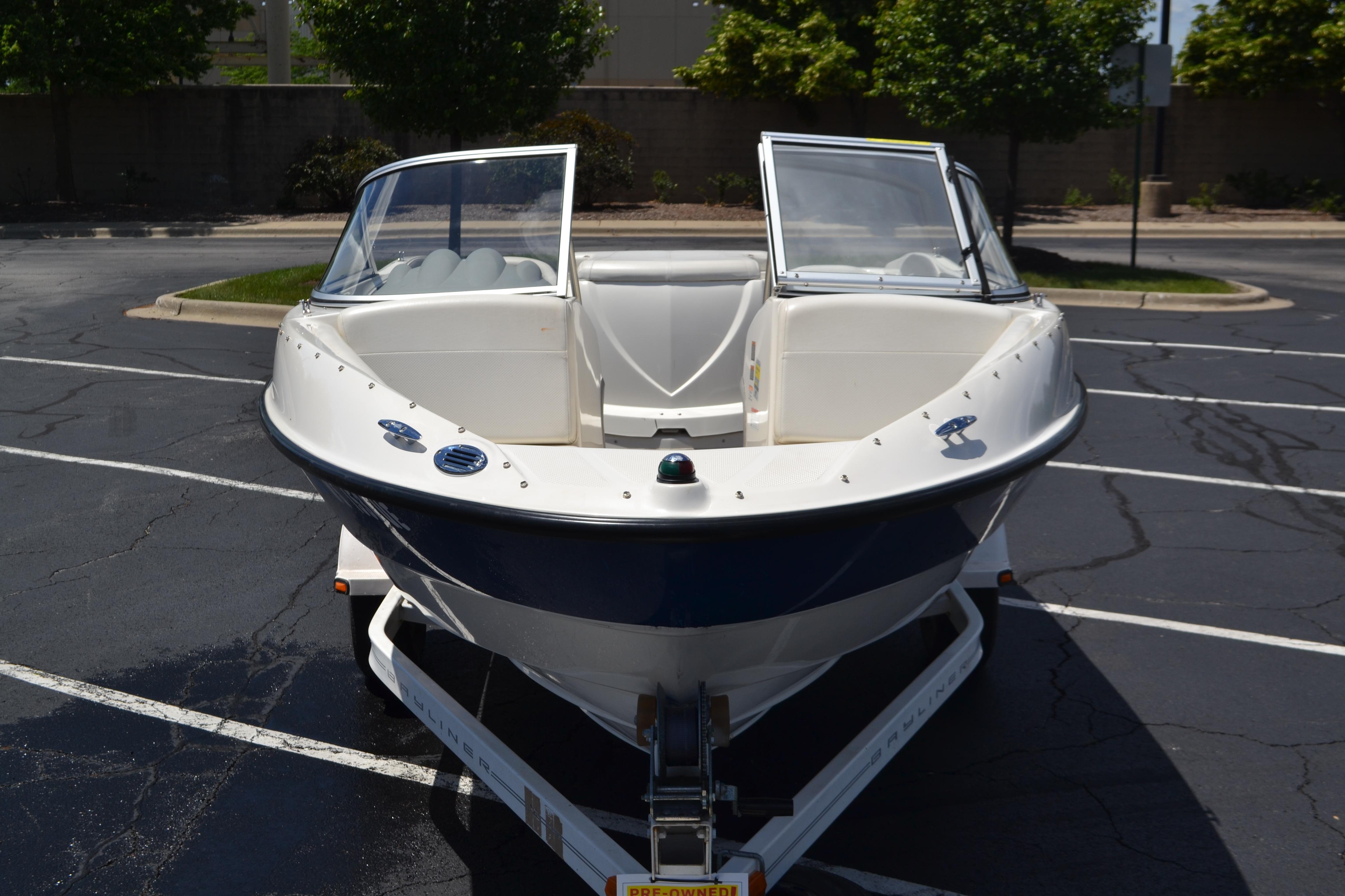 2009 Bayliner 185 Bowrider boat on trailer in parking lot.