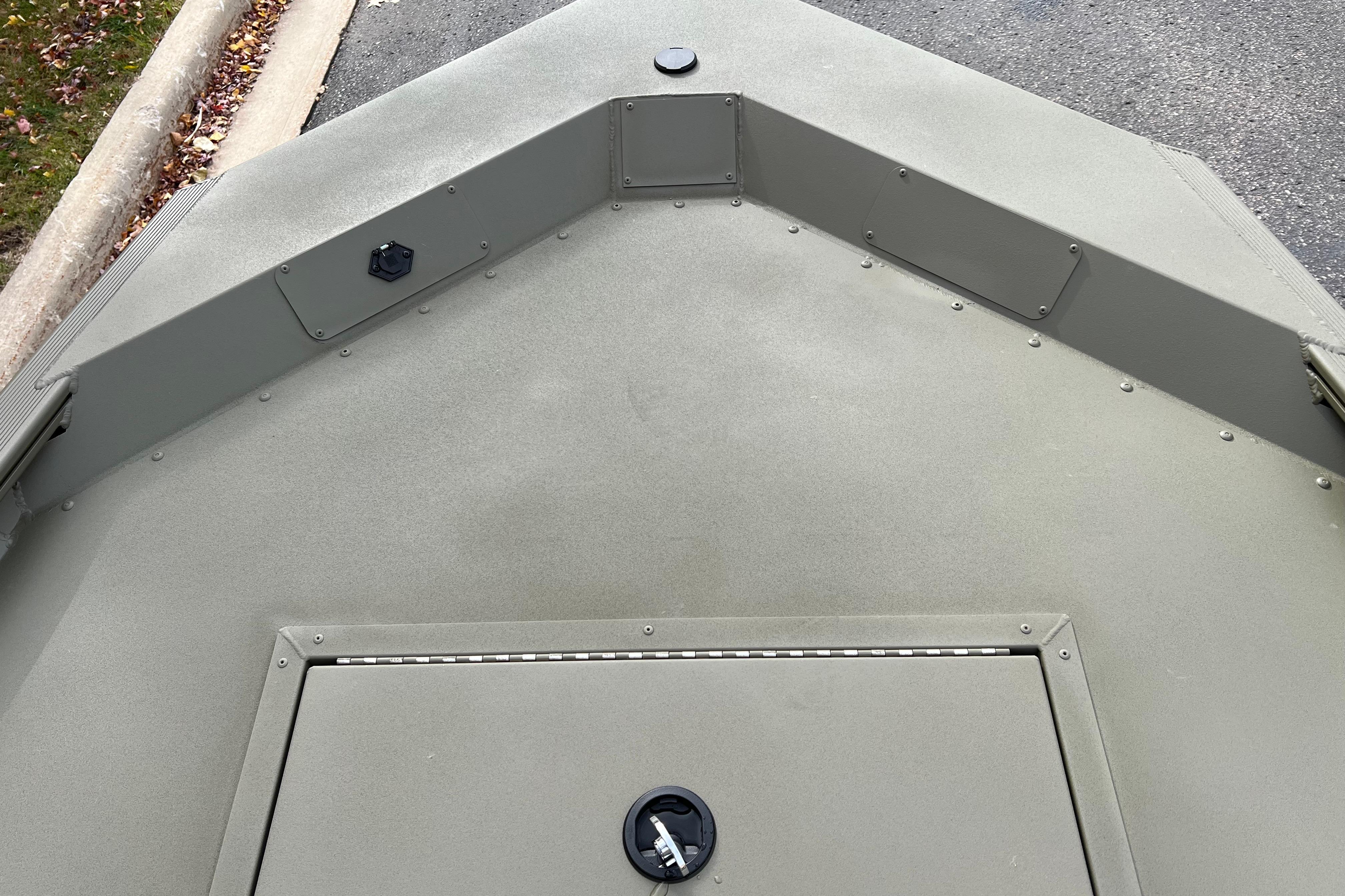 2026 Tracker Grizzly 1648 SC boat deck, featuring a storage compartment and durable design.