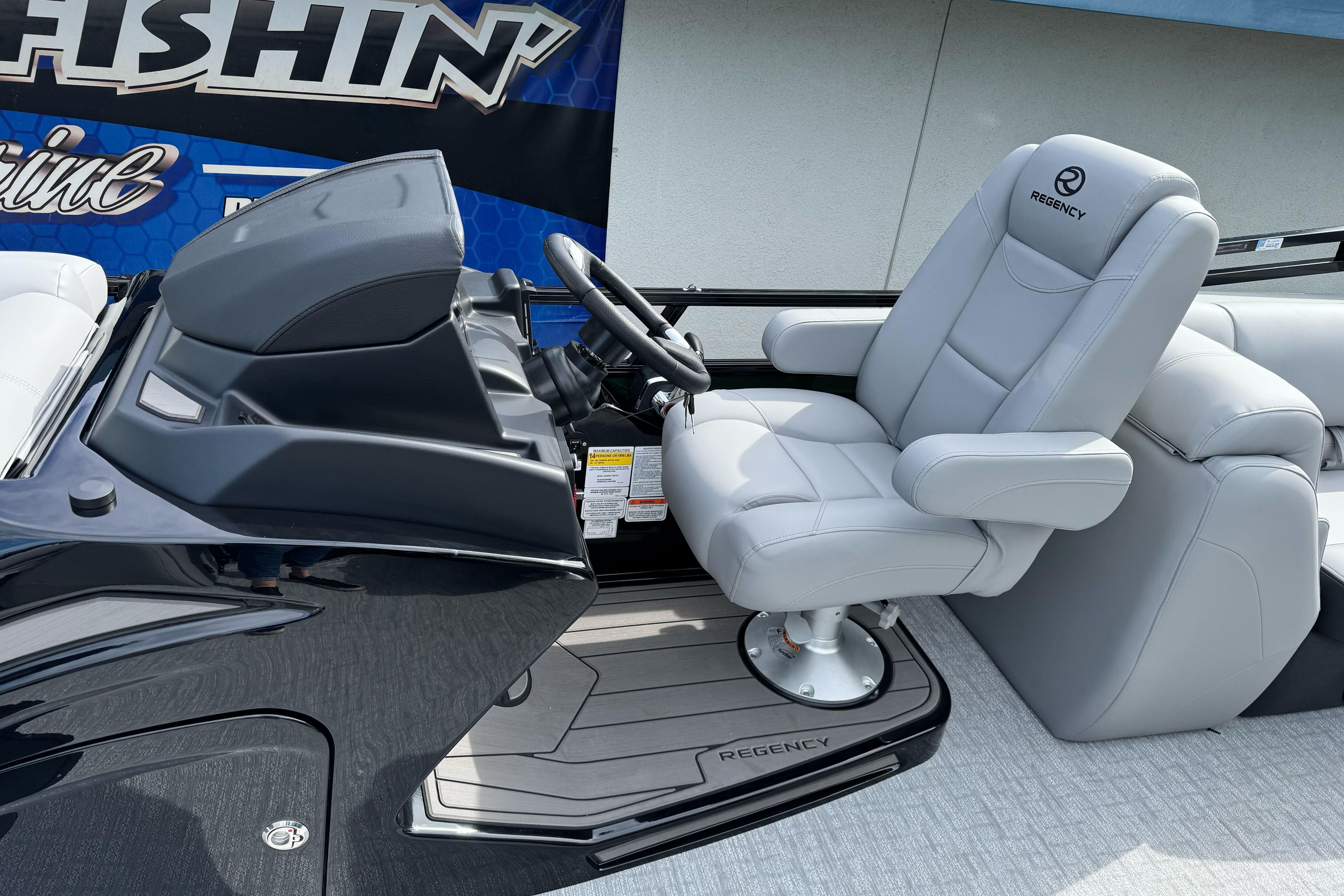 2026 Regency 250 DL boat helm with luxurious gray captain's chair and sleek dashboard design.