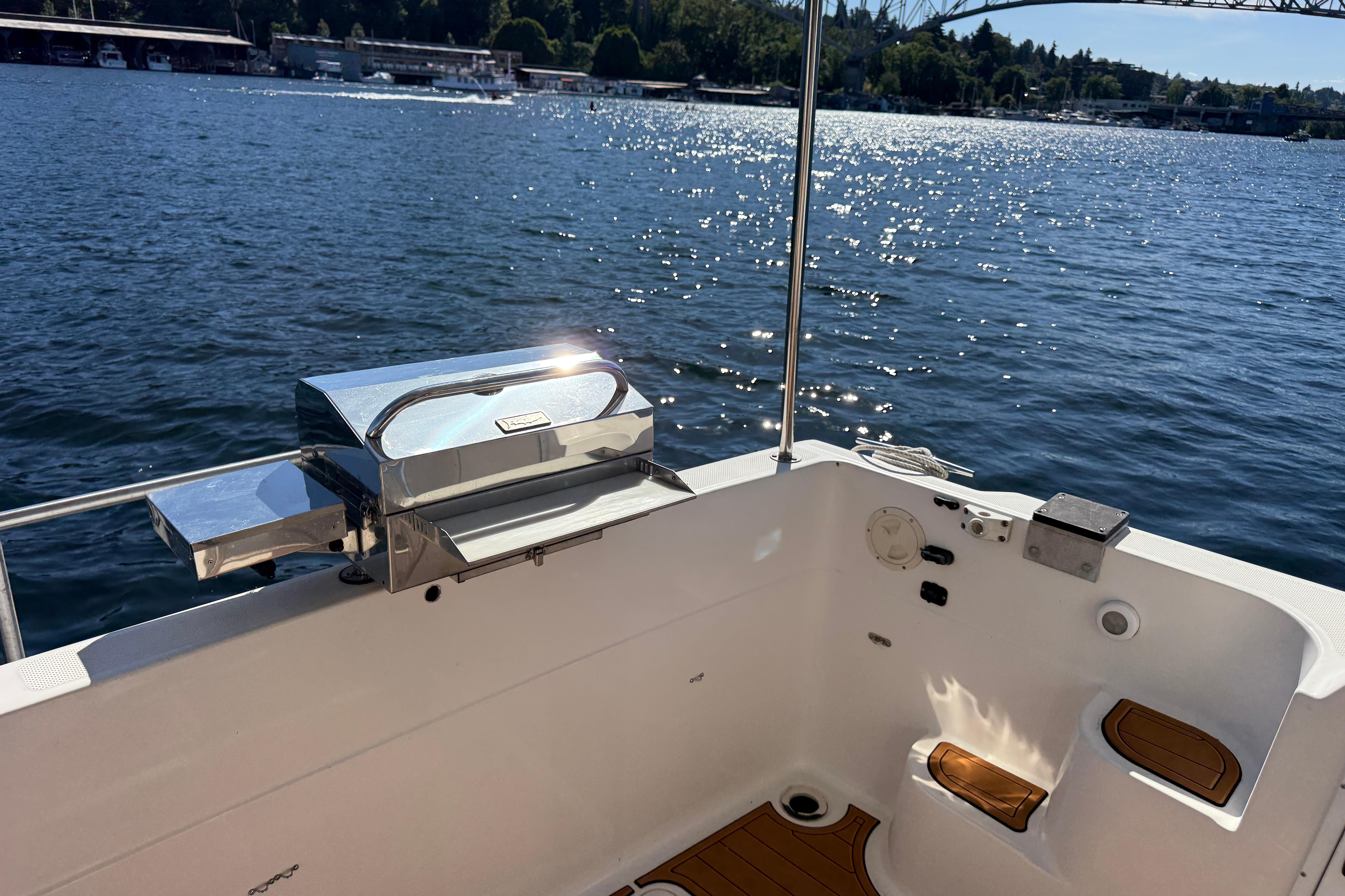 1997 Bayliner 3988 Command Bridge Motoryacht deck with grill, overlooking serene waters.