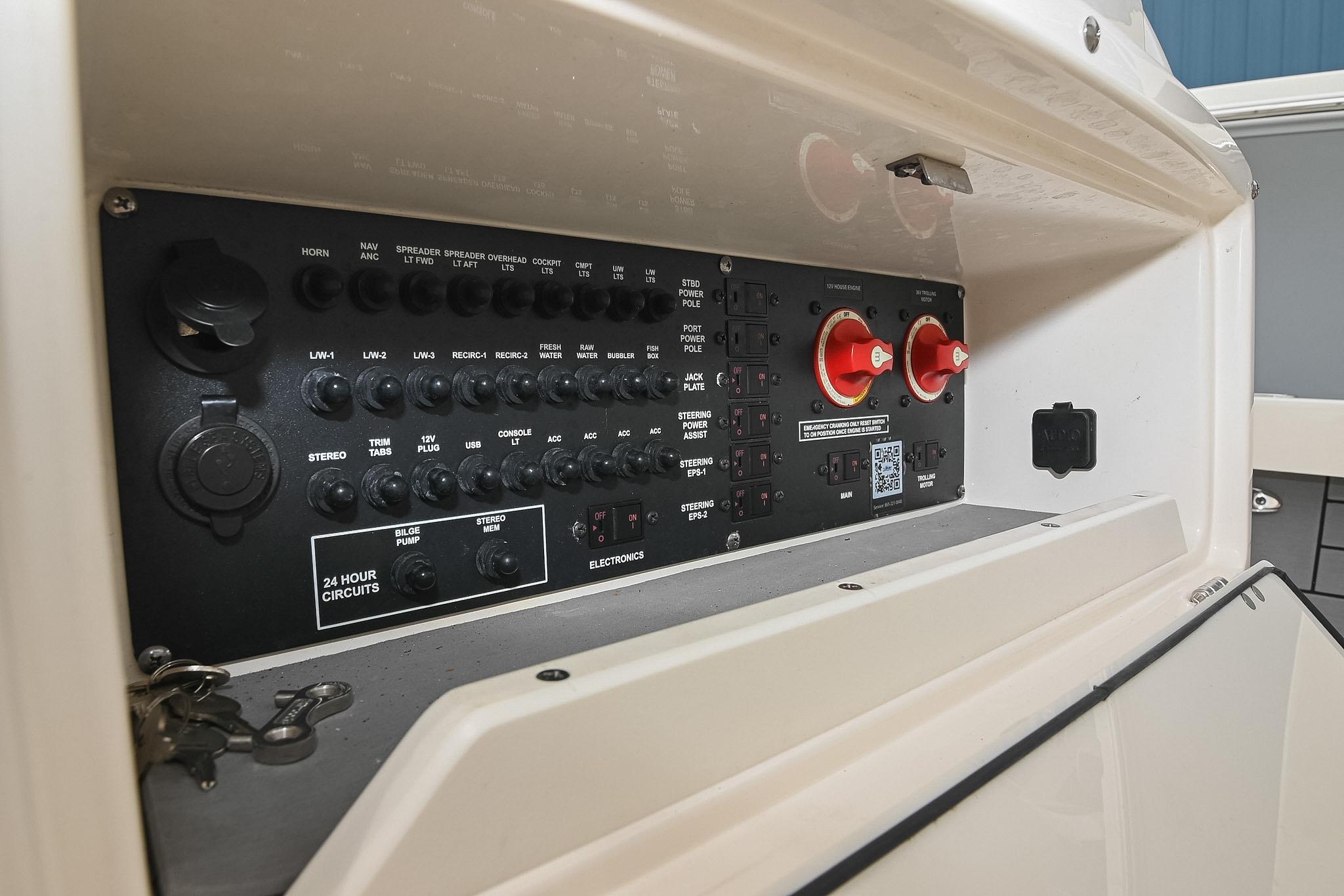 Control panel of a 2021 Pathfinder 2200 TRS boat, featuring various switches and dials.