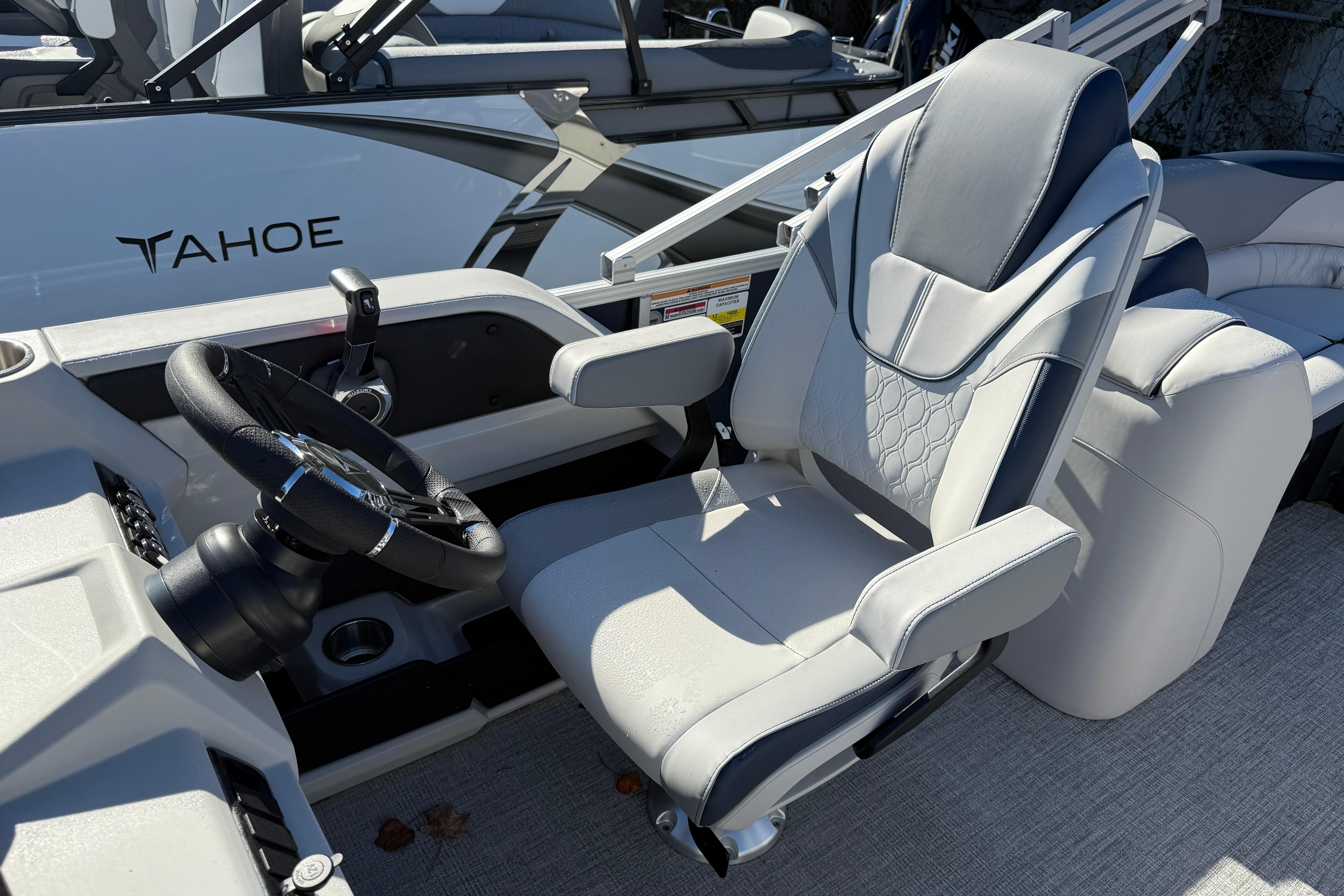 2026 Tahoe Pontoon LTZ Quad Lounger captain's chair and steering wheel.
