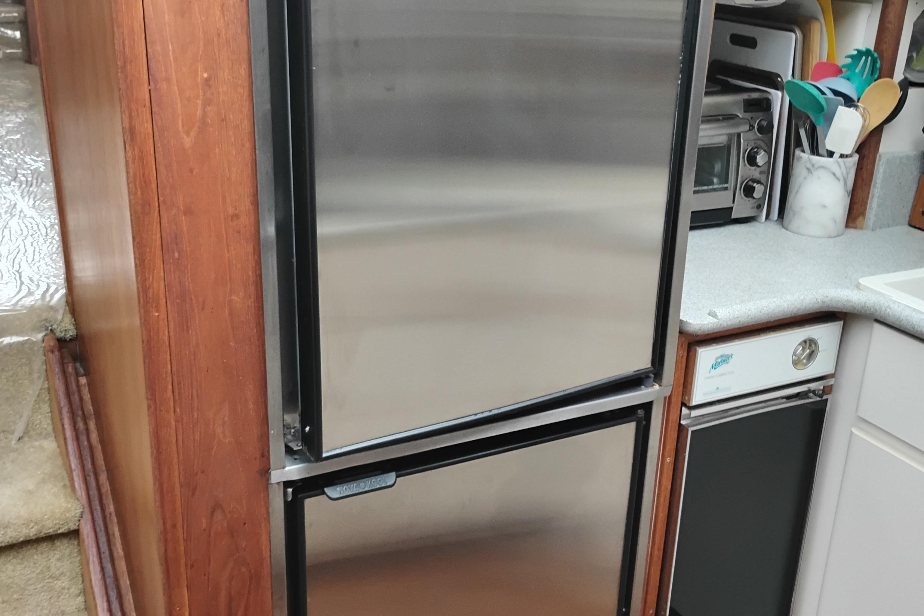 Kitchen area of a 1991 Californian 52 Cockpit Motor Yacht with stainless steel appliances.
