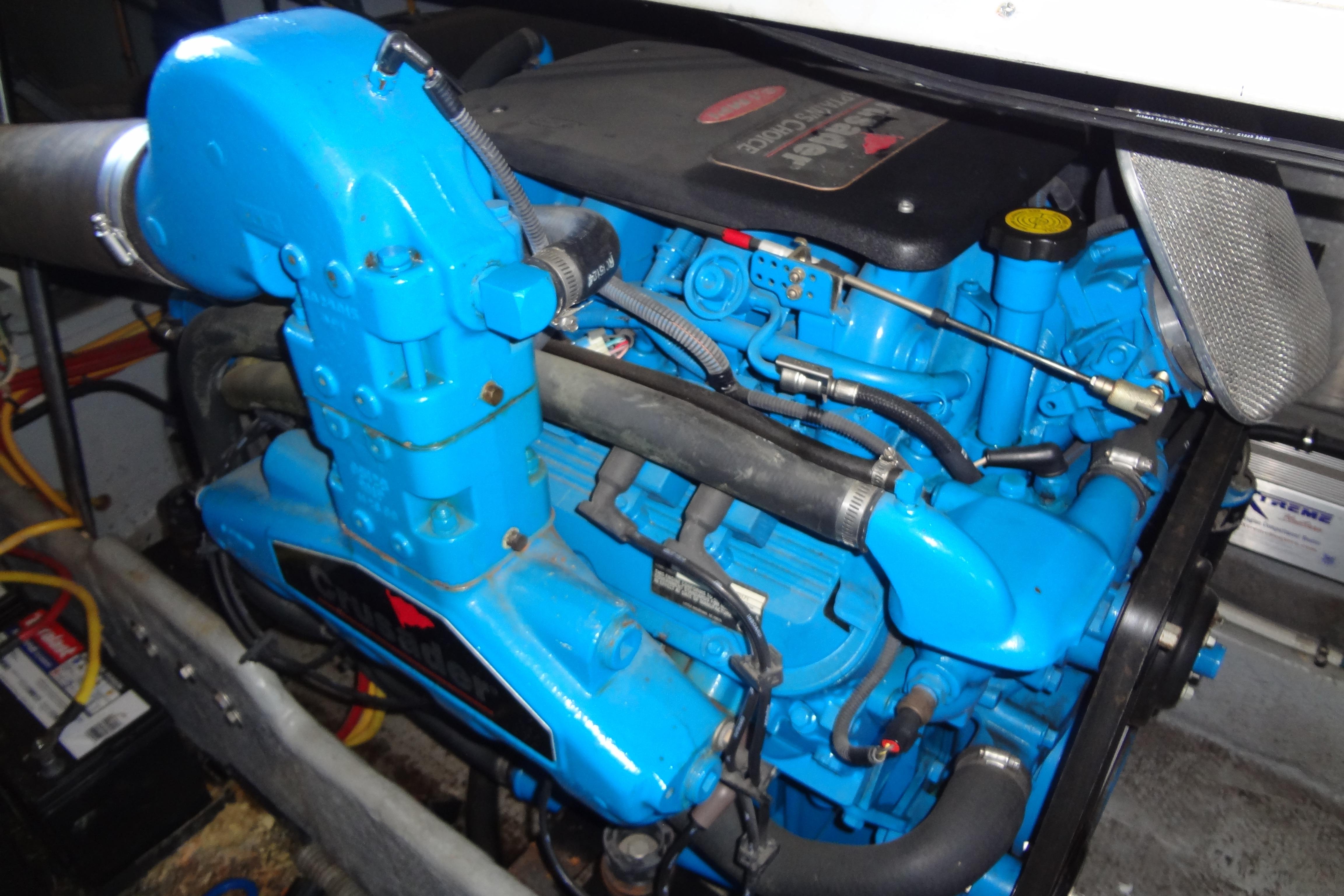 Engine of a 2005 Silverton 34 Convertible boat, featuring vibrant blue components.