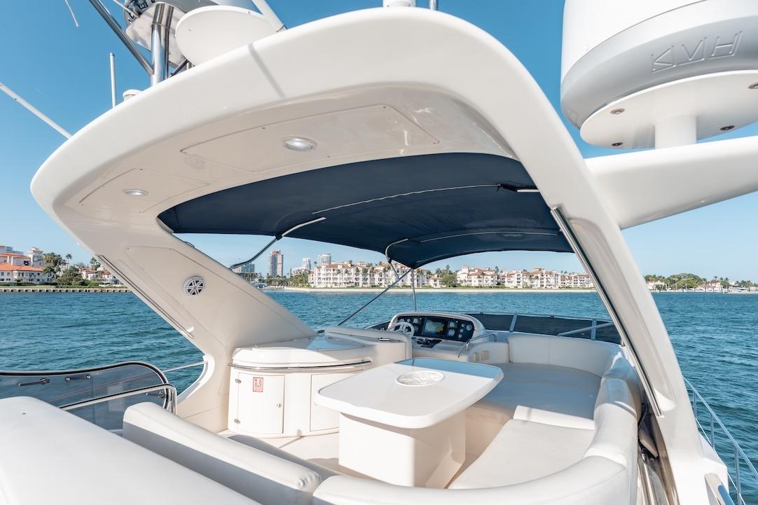 Luxurious 2007 Azimut 62 Evolution yacht with spacious deck and scenic waterfront view.