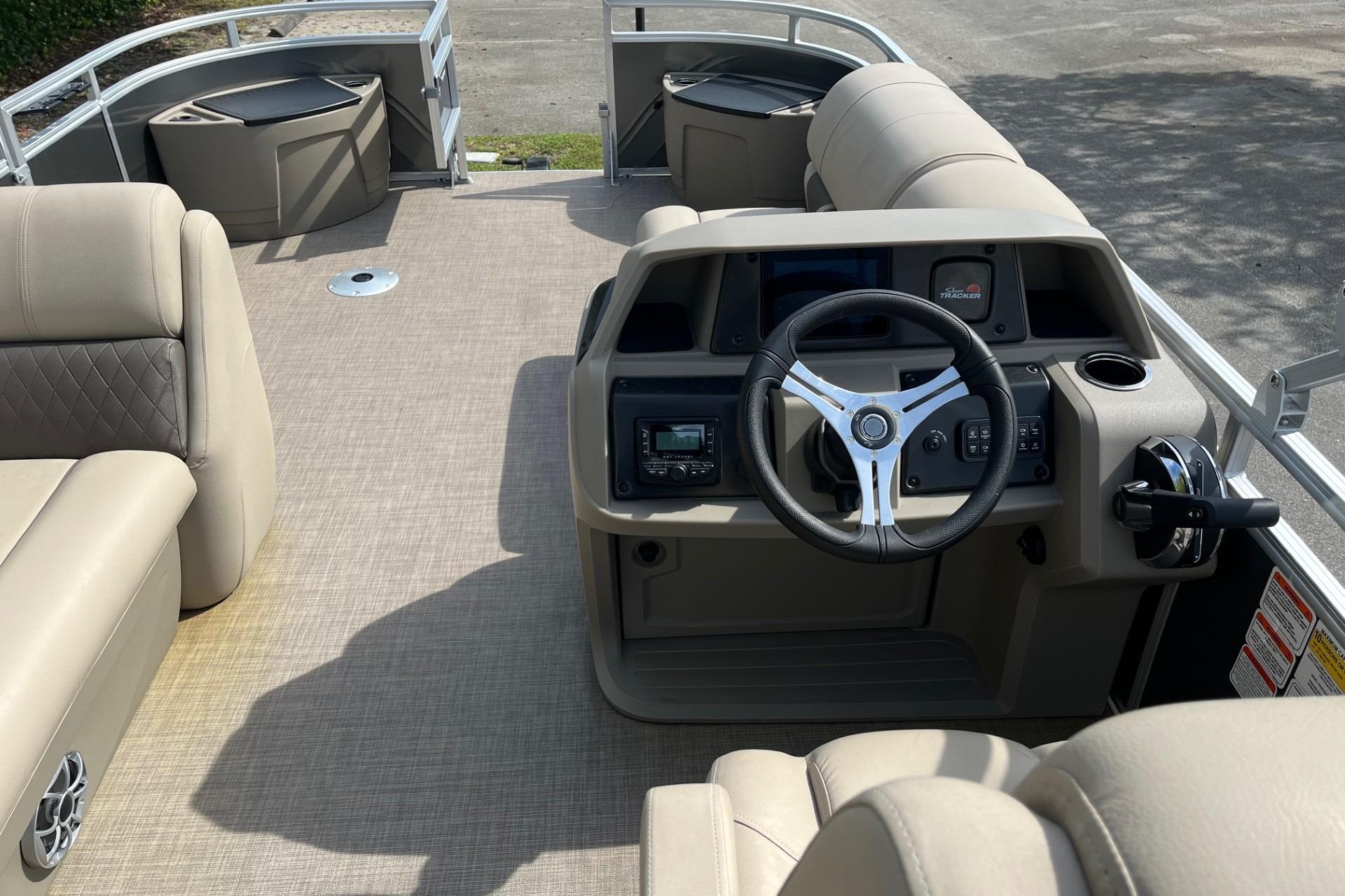 2025 Sun Tracker Fishin' Barge 20 DLX interior with steering console and seating.