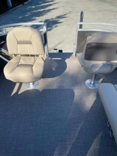 2024 Sun Tracker Fishin' Barge 20 DLX boat interior with two beige seats.