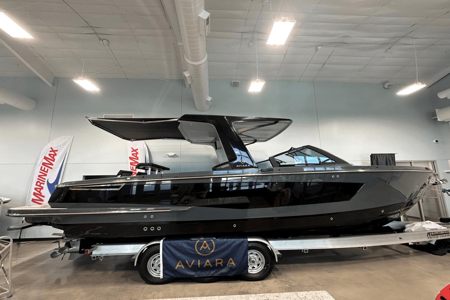 2023 Aviara AV32 boat displayed indoors on a trailer at MarineMax showroom.
