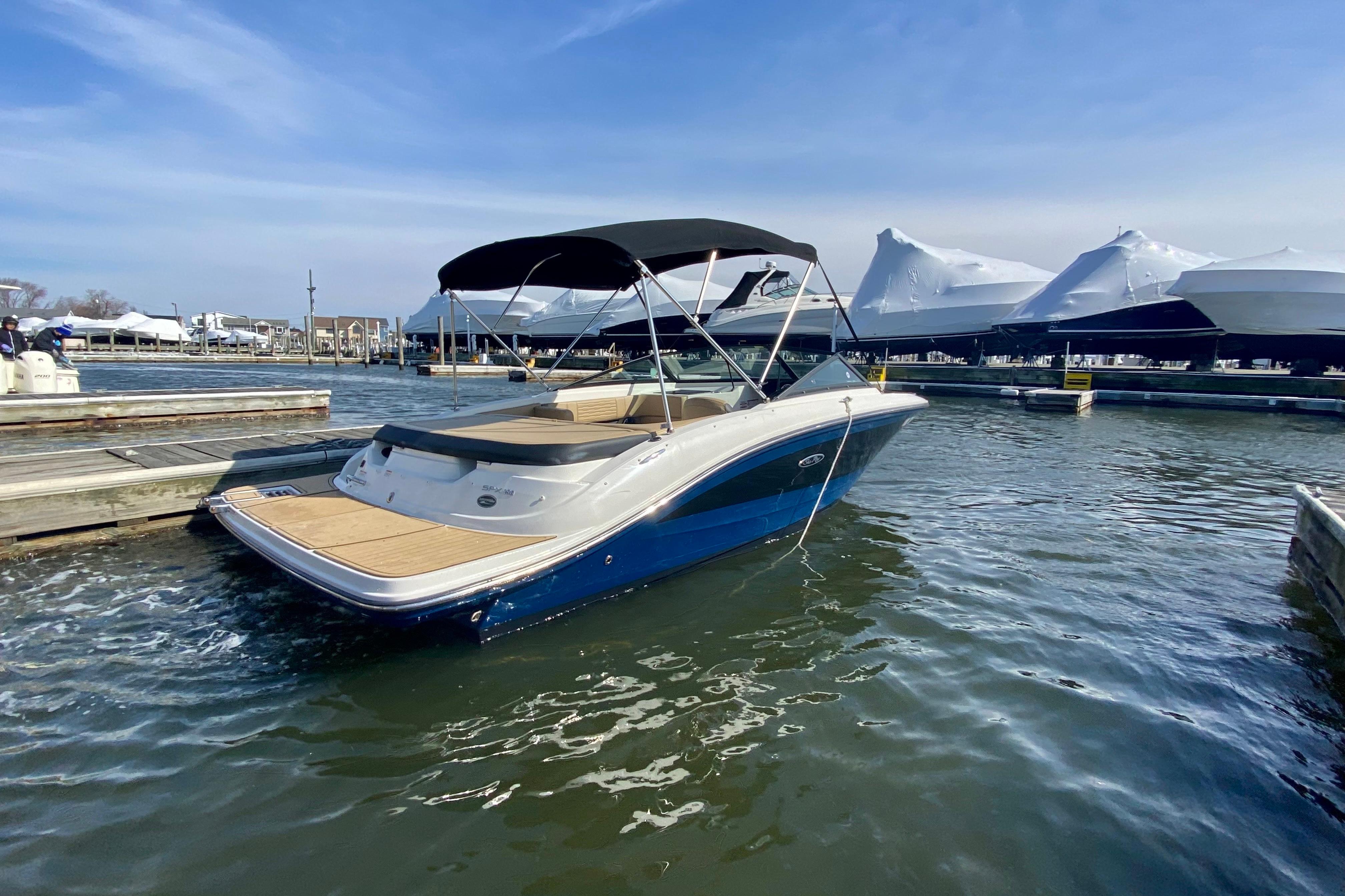 2021 Sea Ray SPX 190 boat docked in marina under clear blue sky.