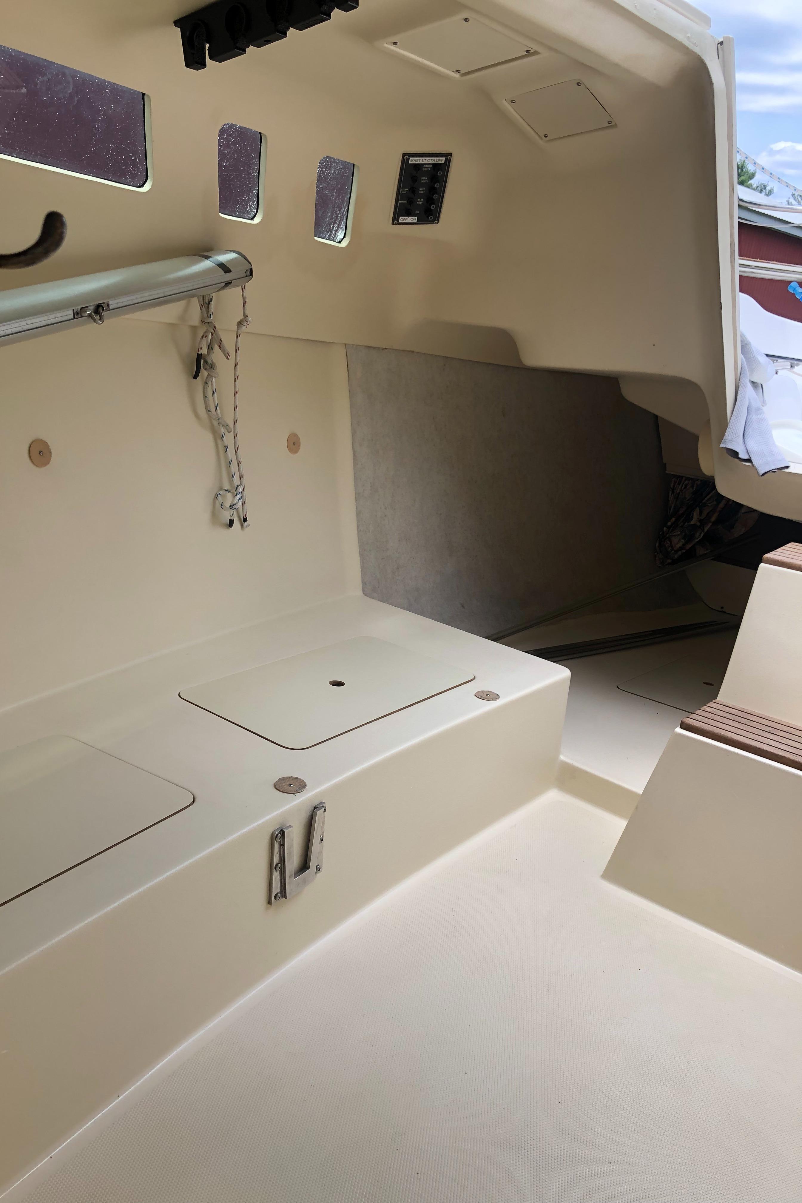 Interior of a 1998 Hunter 240 sailboat, featuring seating and storage compartments.