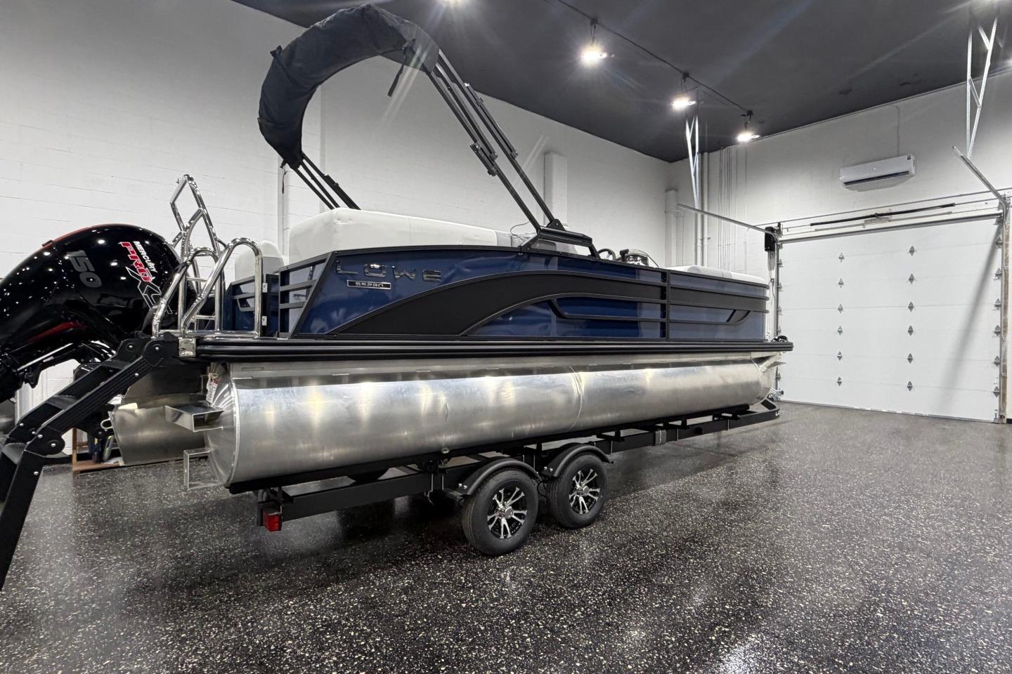 2026 Lowe SS 230 WT pontoon boat in a showroom, featuring sleek design and modern amenities.