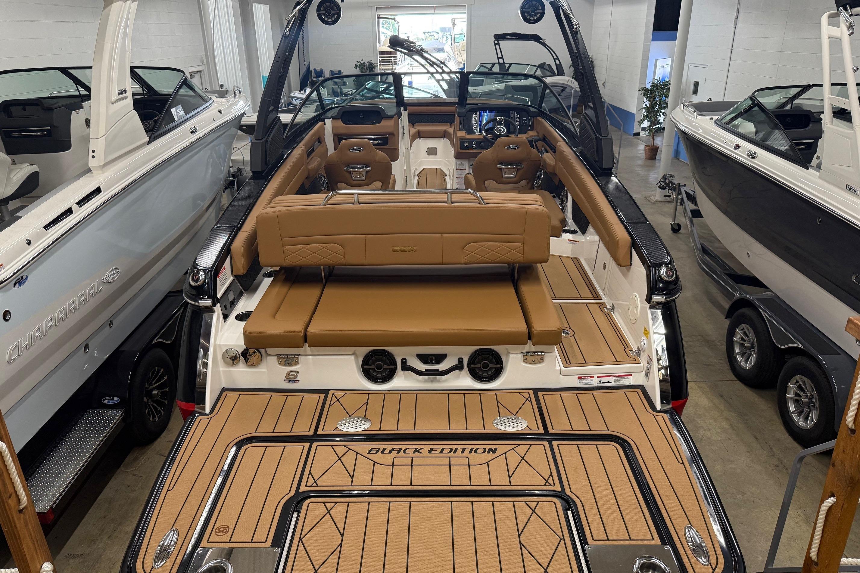 2026 Chaparral SSX 6 boat interior with tan seating and sleek design in showroom.