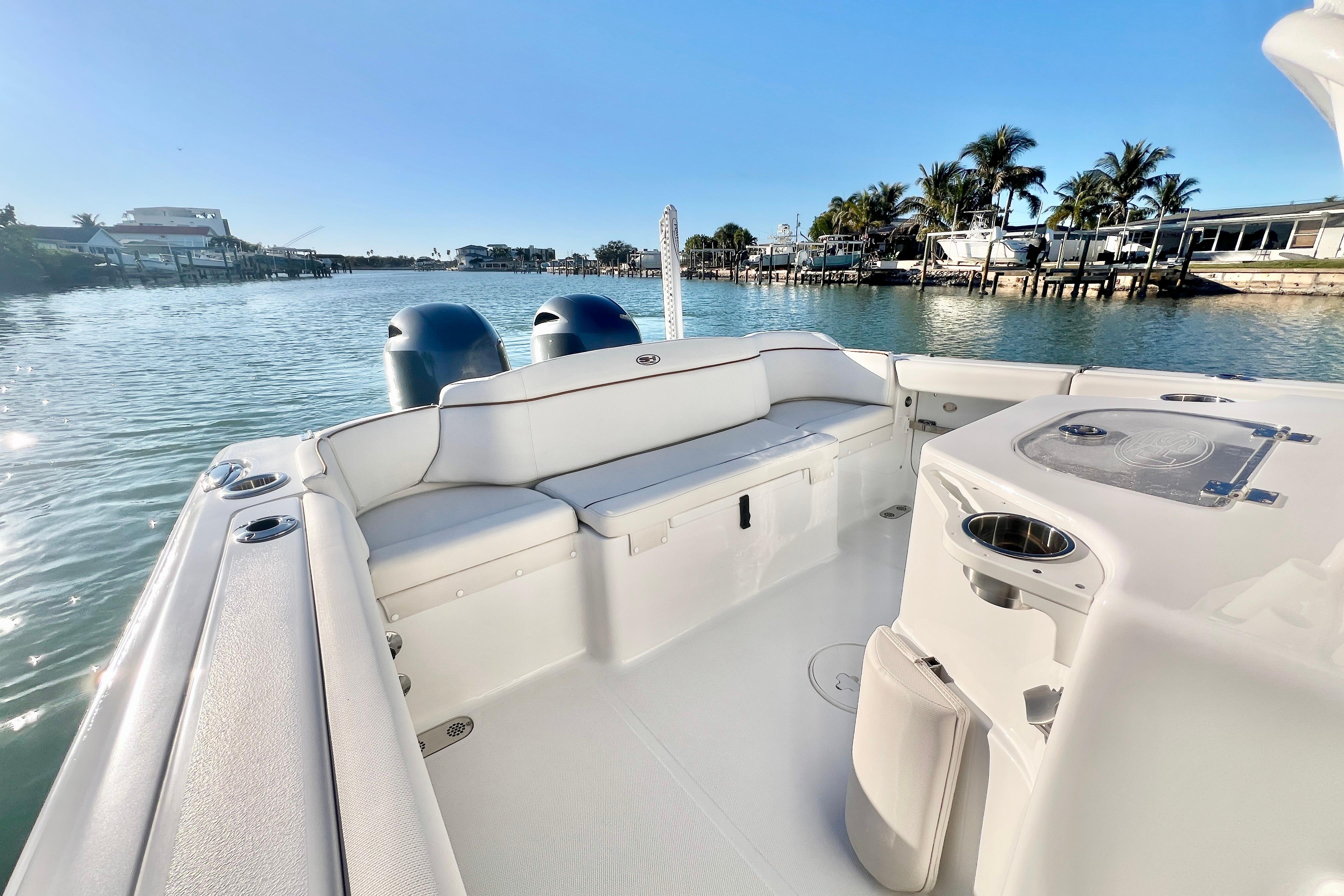 2022 Sea Hunt Ultra 265 SE boat interior with scenic waterfront view.