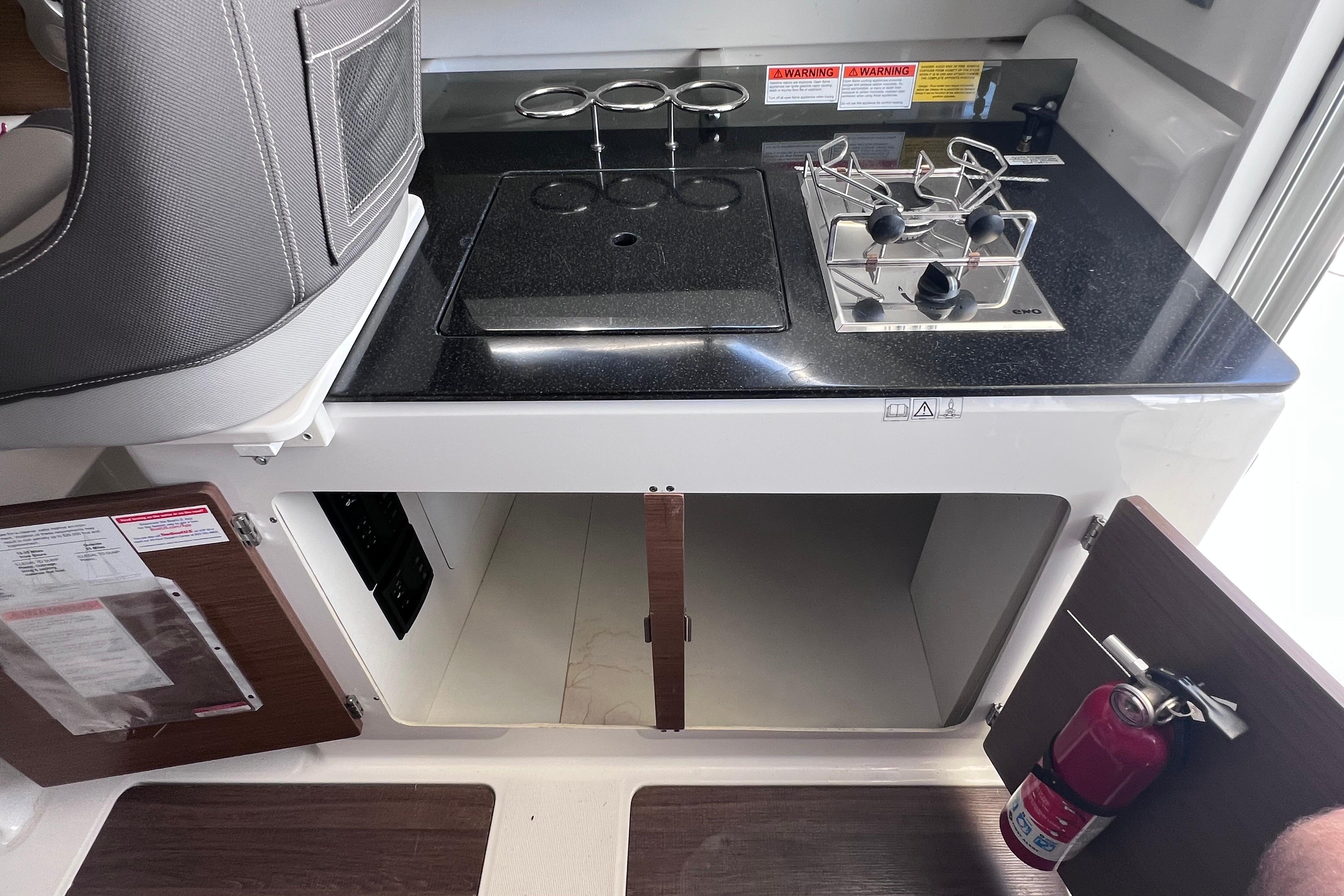Interior of 2021 Jeanneau NC Weekender 795 Series 2 with kitchenette and storage.