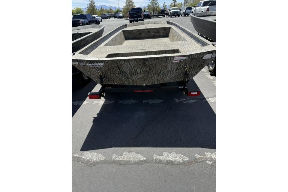 2026 Tracker Grizzly 1860 Utility boat in parking lot, showcasing rugged design.