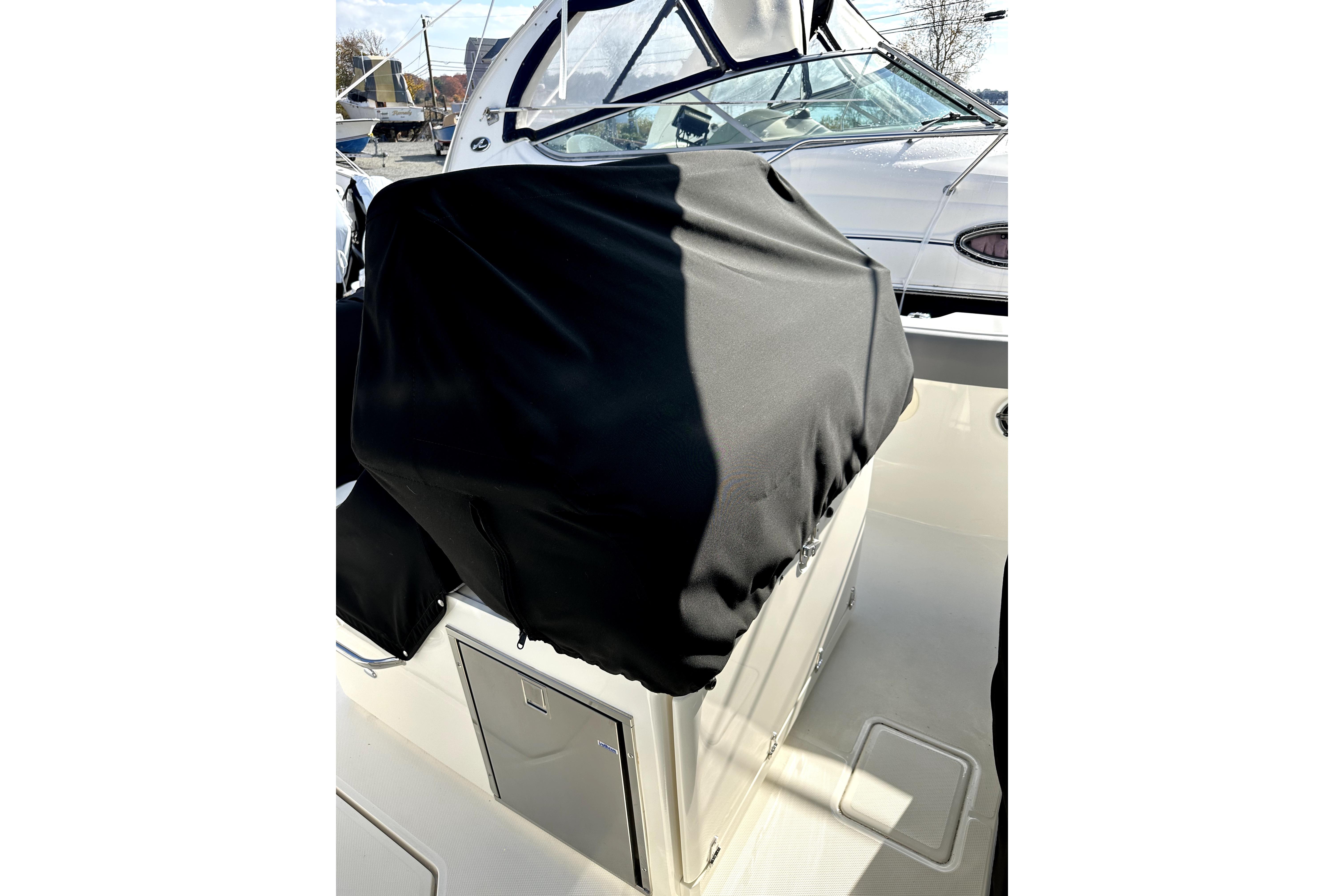 2023 Boston Whaler OUTRAGE boat interior with covered console and windshield.