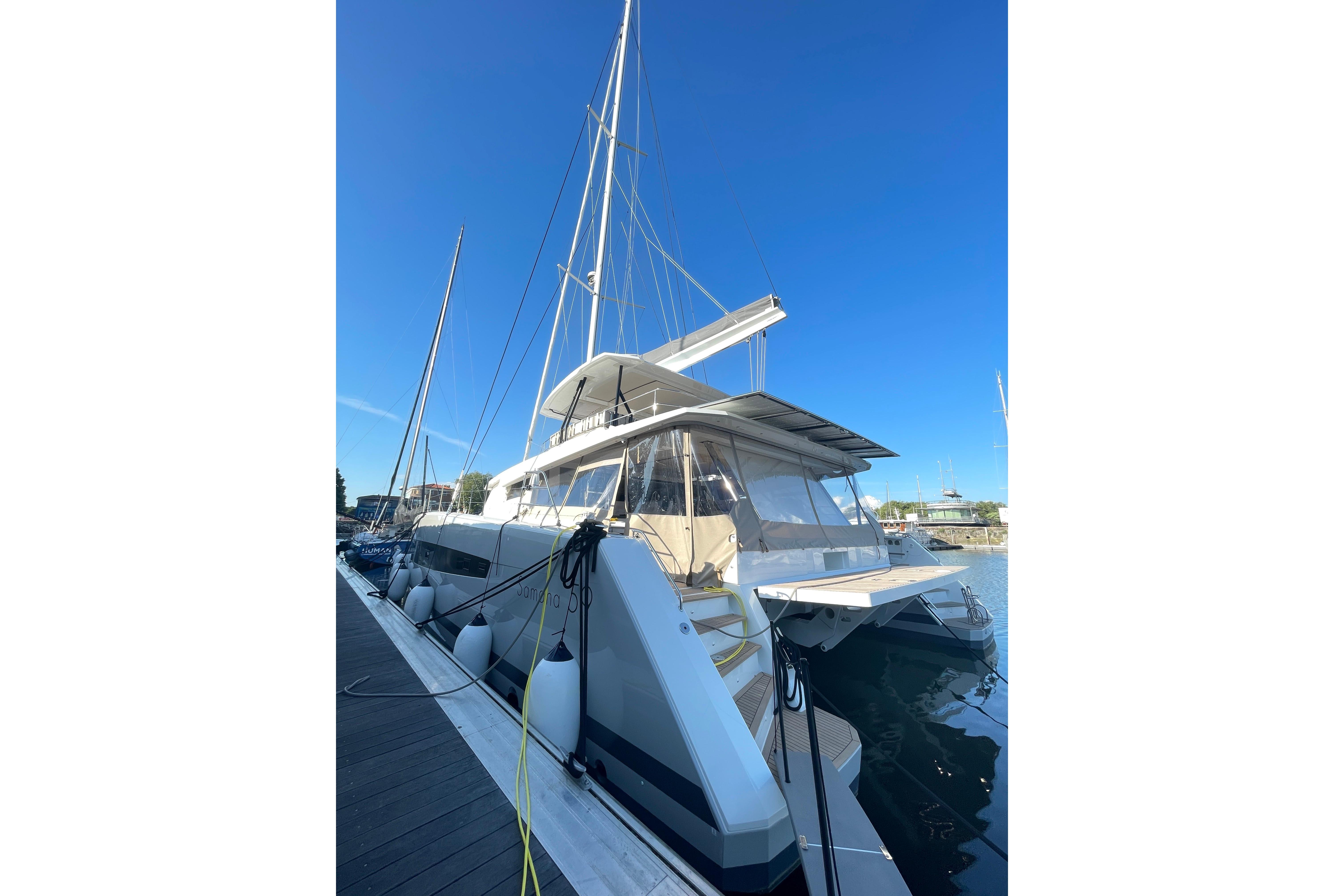 2023 Fountaine Pajot Samana 59 catamaran docked under clear blue sky.