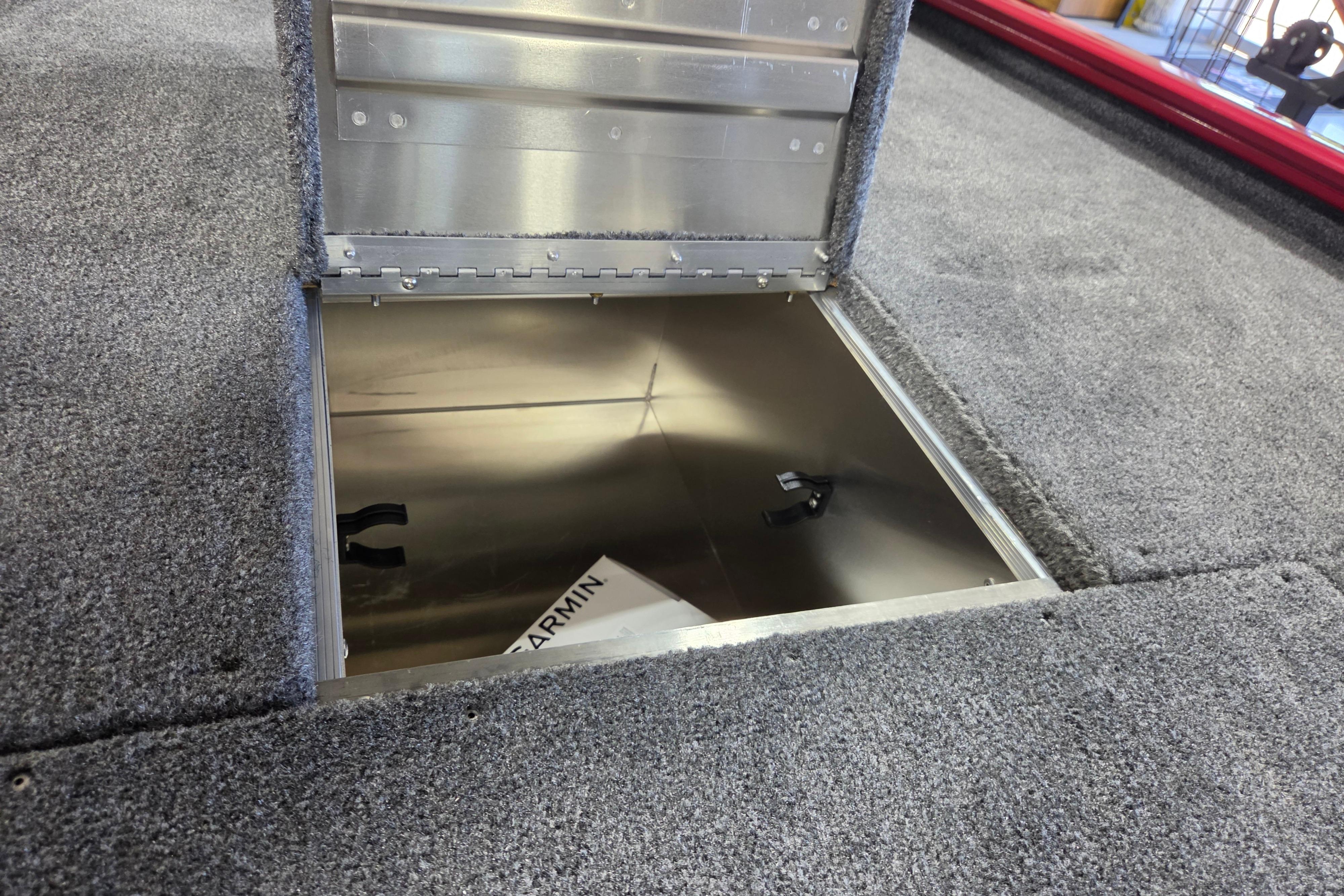 Open storage compartment in 2026 Tracker Pro 170 boat, featuring carpeted interior.