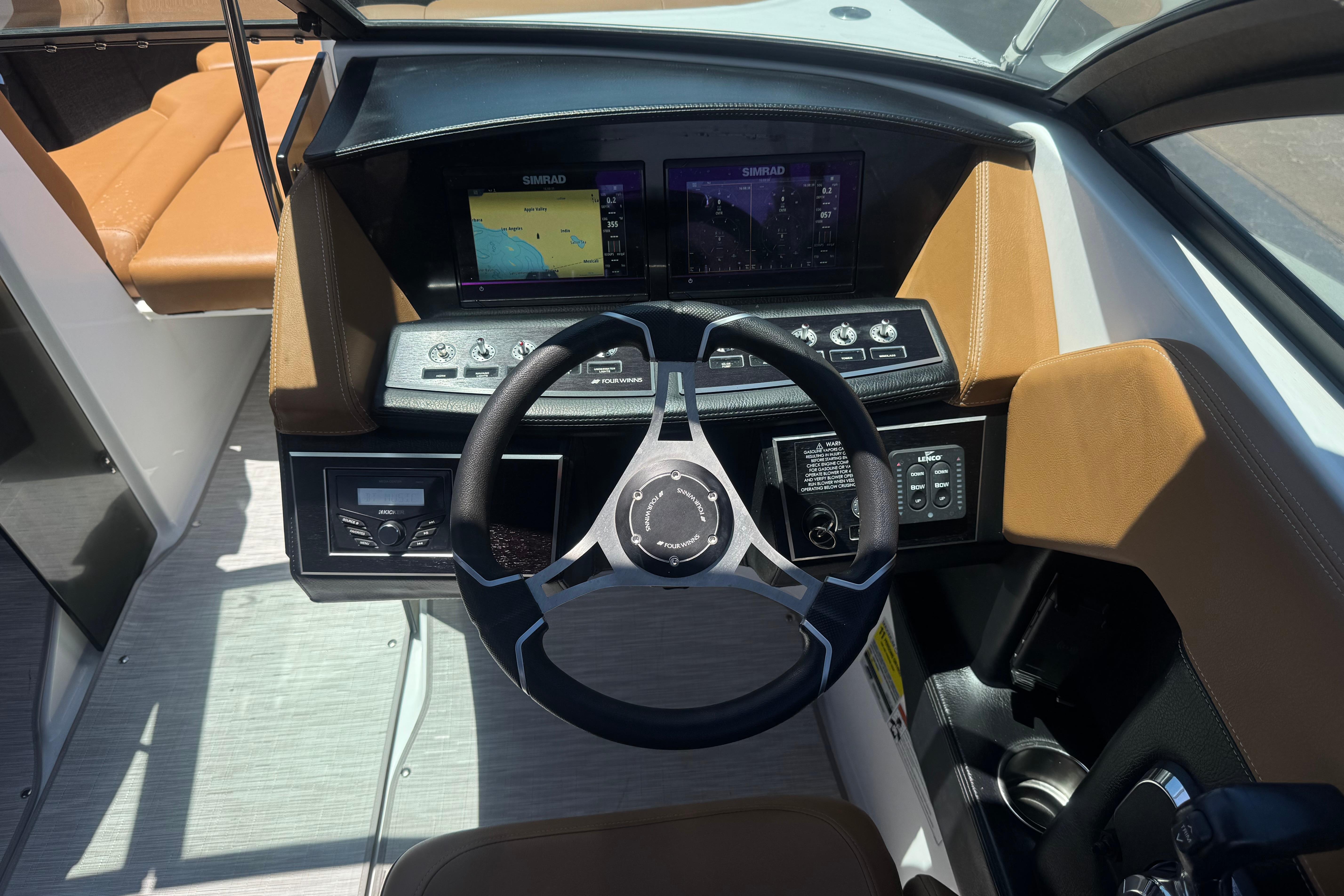 2022 Four Winns H4 boat dashboard with steering wheel and navigation displays.