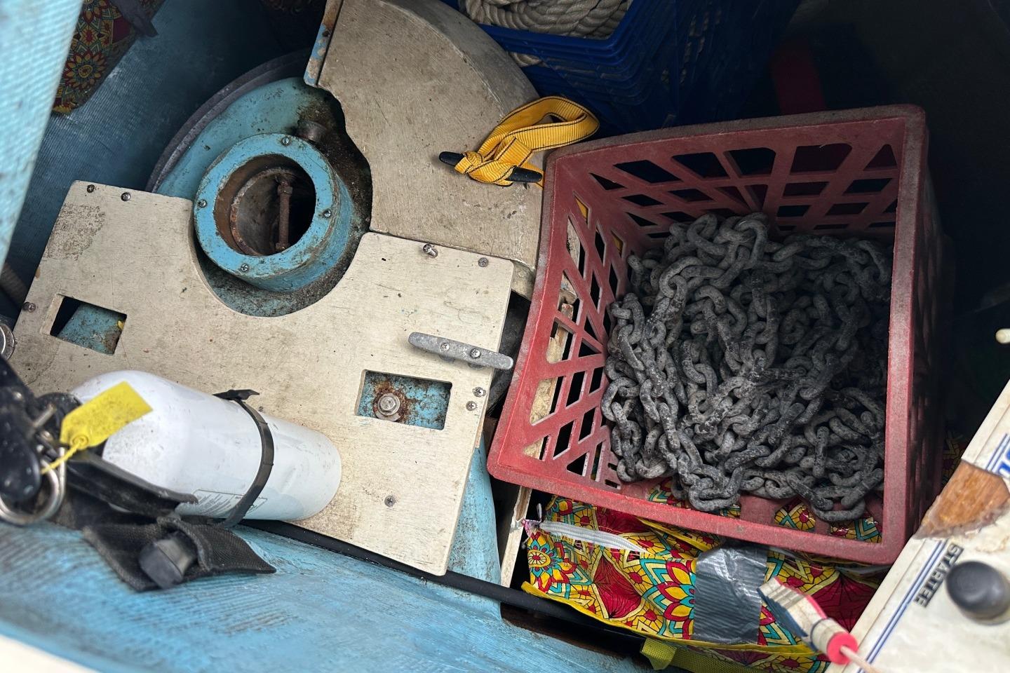 Storage compartment of a 1991 Sabre 425 with chains and equipment.