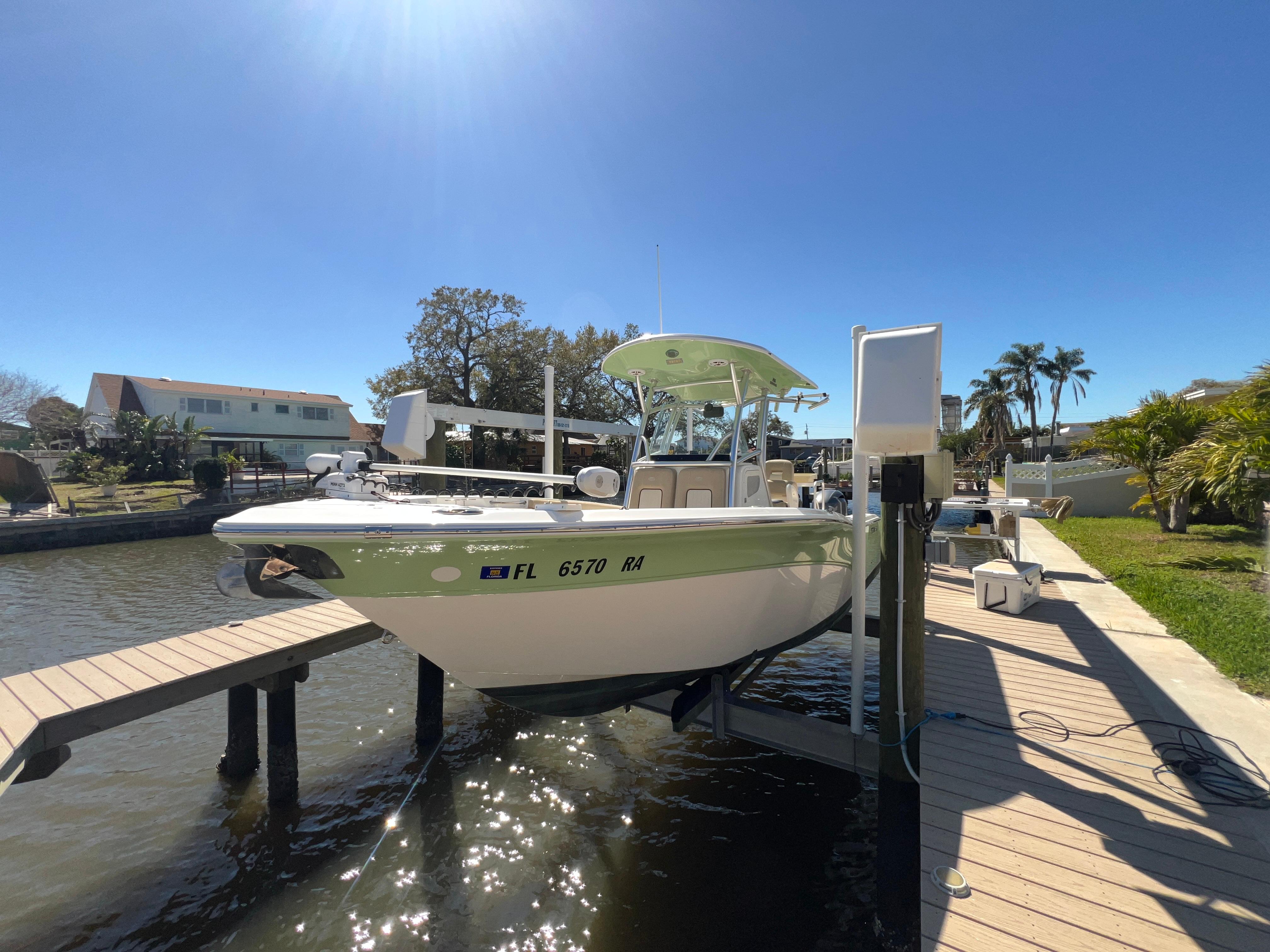2016 Sea Fox 266 Commander boat docked on a sunny day.