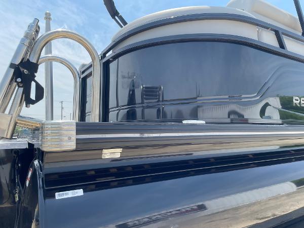 2023 Regency 250 LE3 pontoon boat, sleek black exterior, stainless steel railings.