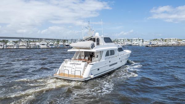 Grand Harbour 76 yacht cruising in a marina, 2001 model.