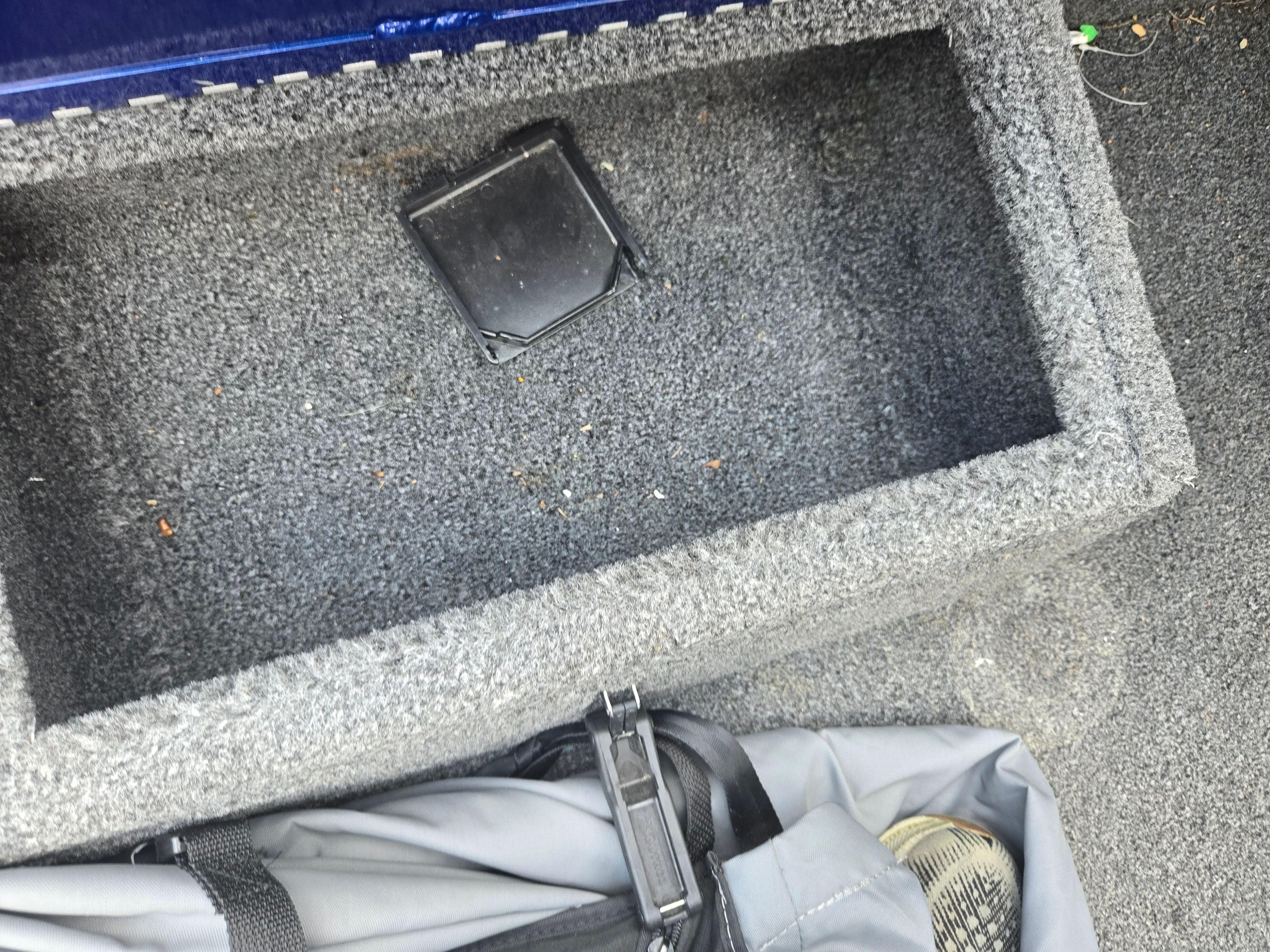 Carpeted storage compartment in a 2021 Lowe Stinger 188 boat.