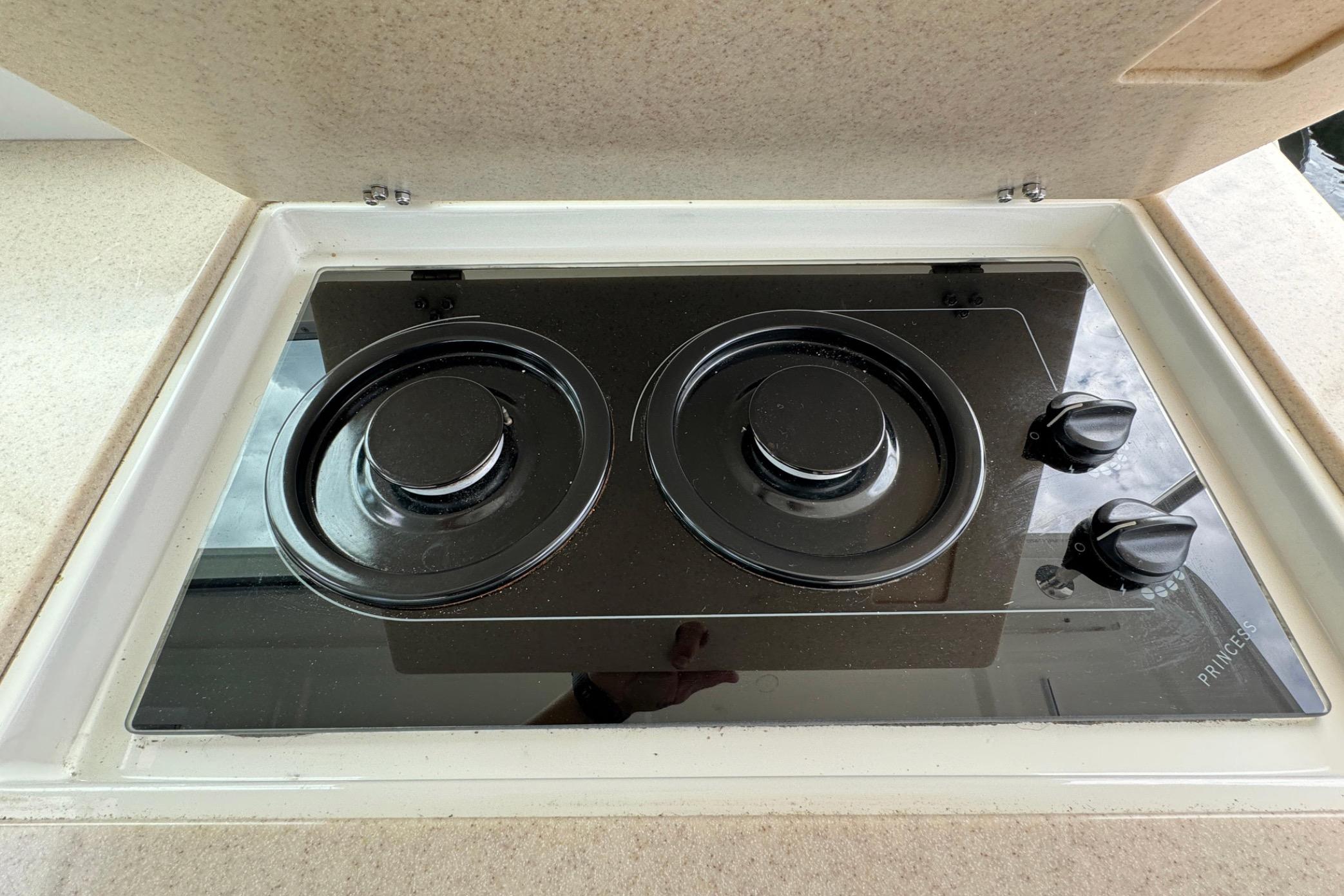 Stovetop on 2008 Back Cove 33 yacht, featuring two burners and control knobs.