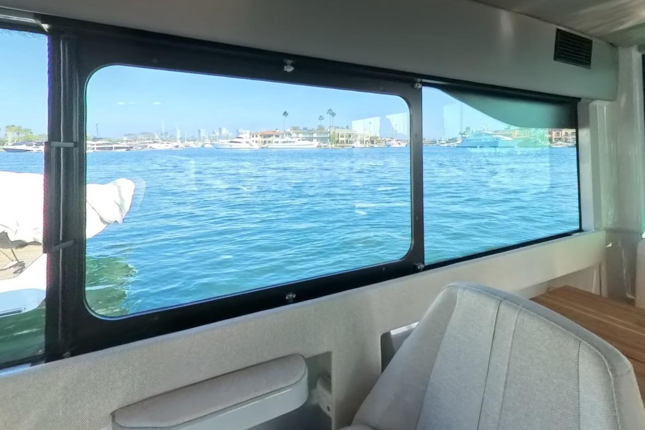 Interior view from 2024 Saxdor 320 GTC, showcasing marina through large window.