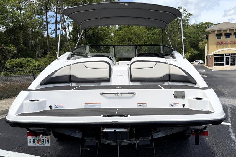 2017 Yamaha Boats SX210 with canopy, parked in a lot, rear view.