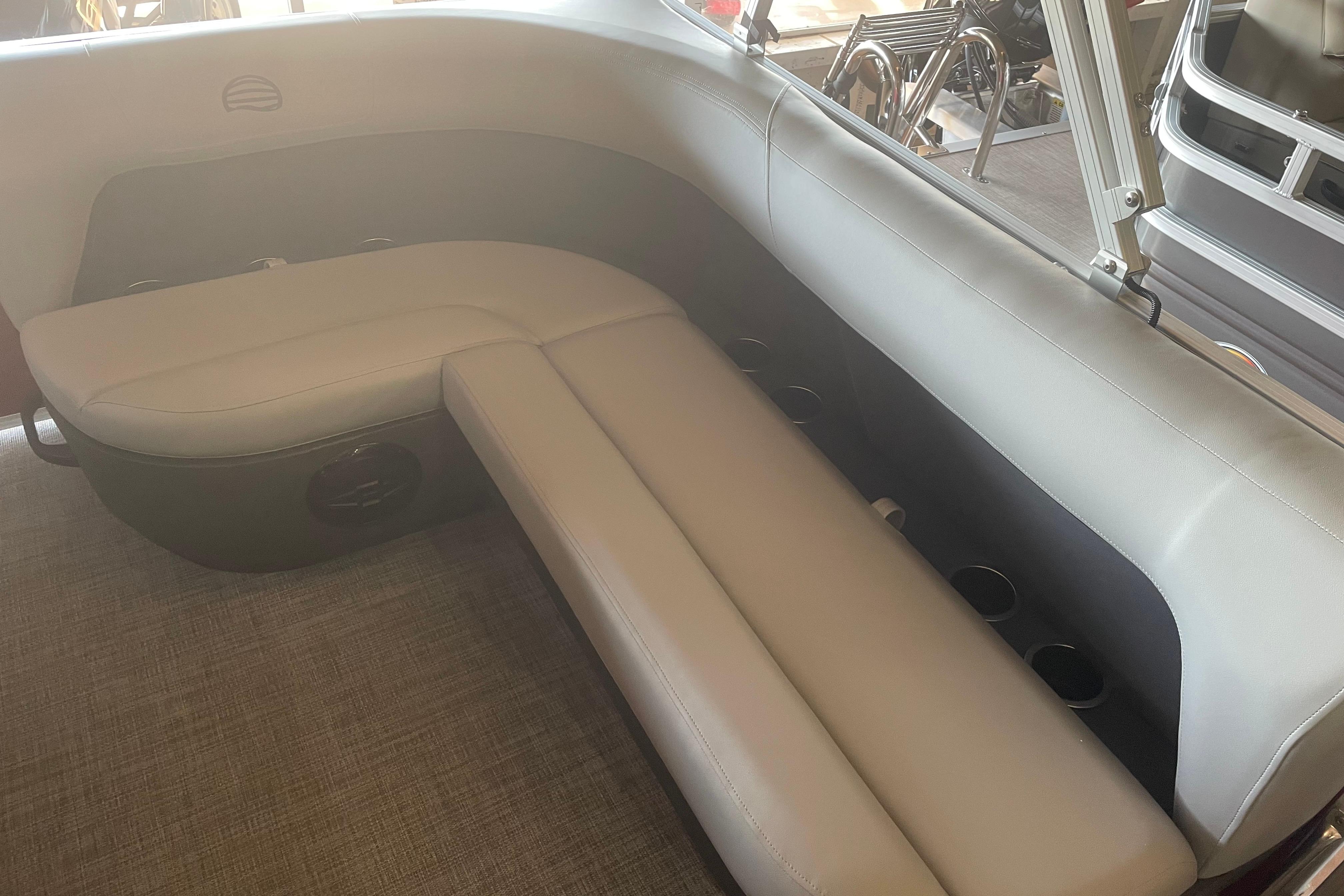 Interior seating of 2026 Sun Tracker Party Barge 16 DLX with cup holders.