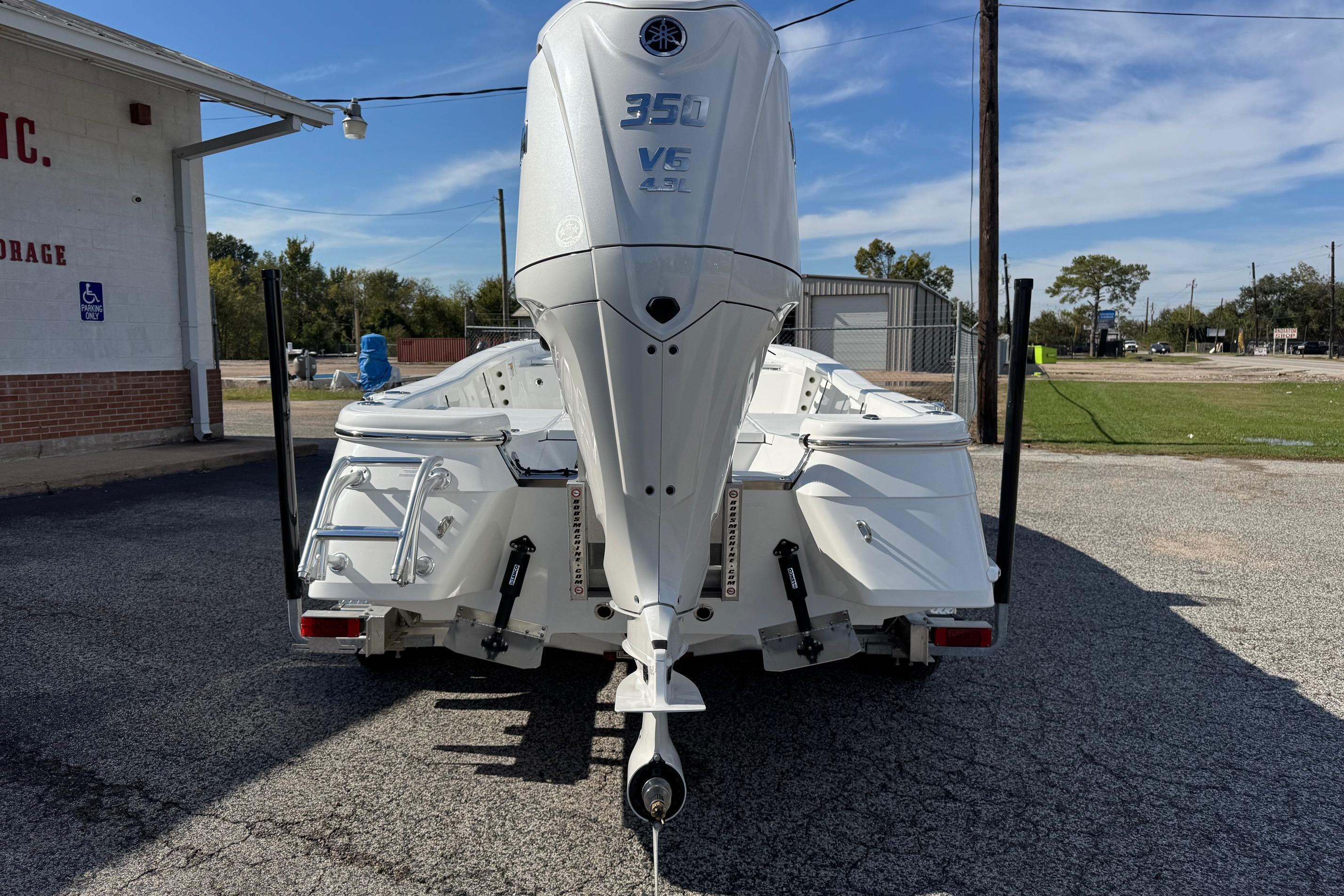 2026 BlackJack 256 Bay boat with Yamaha 350 engine, parked outdoors.