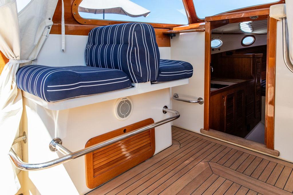 Hinckley Picnic Boat 36 Classic 2000 interior with striped cushions and wooden accents.