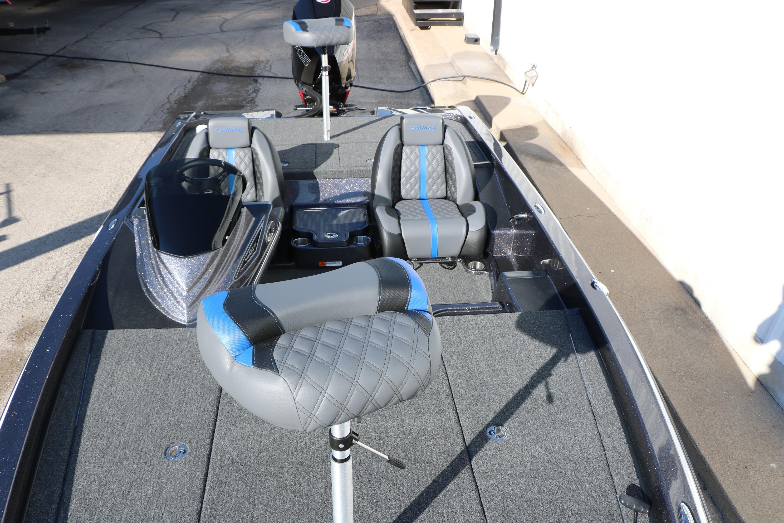 2027 Caymas 201 Pro boat interior with gray and blue seating, showcasing modern design.