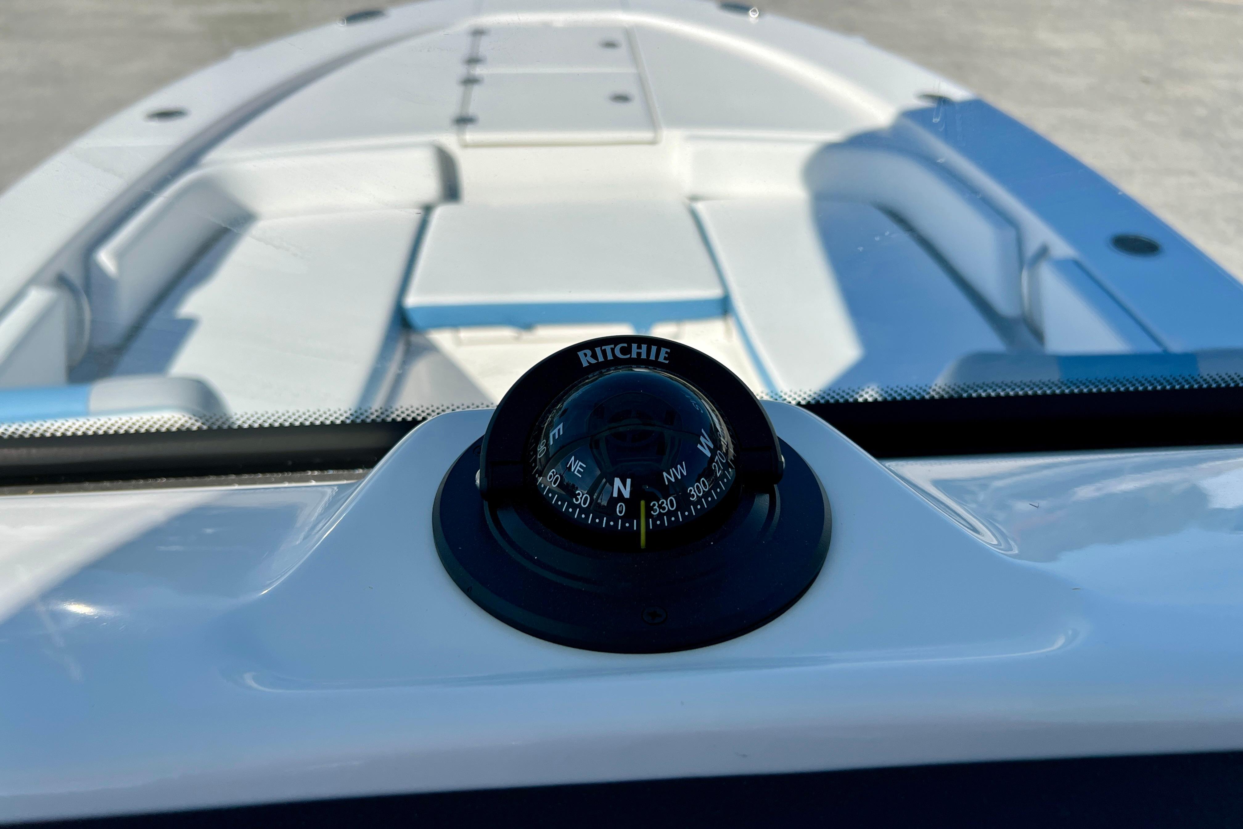 Compass on 2026 Robalo 246 Cayman boat, showcasing sleek interior design.