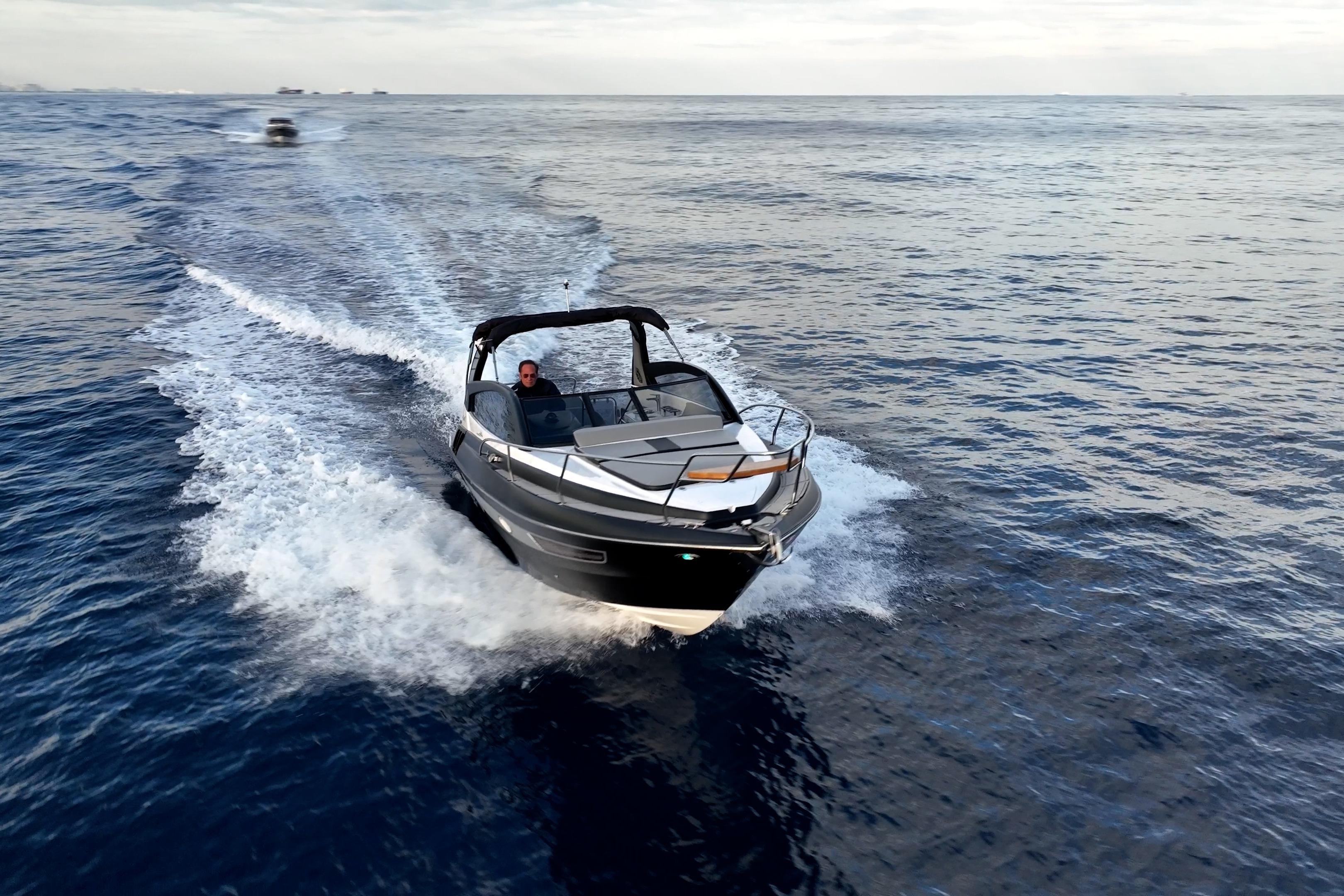 A sleek 2027 Hanover 305 boat cruising on open water, creating a dynamic wake.