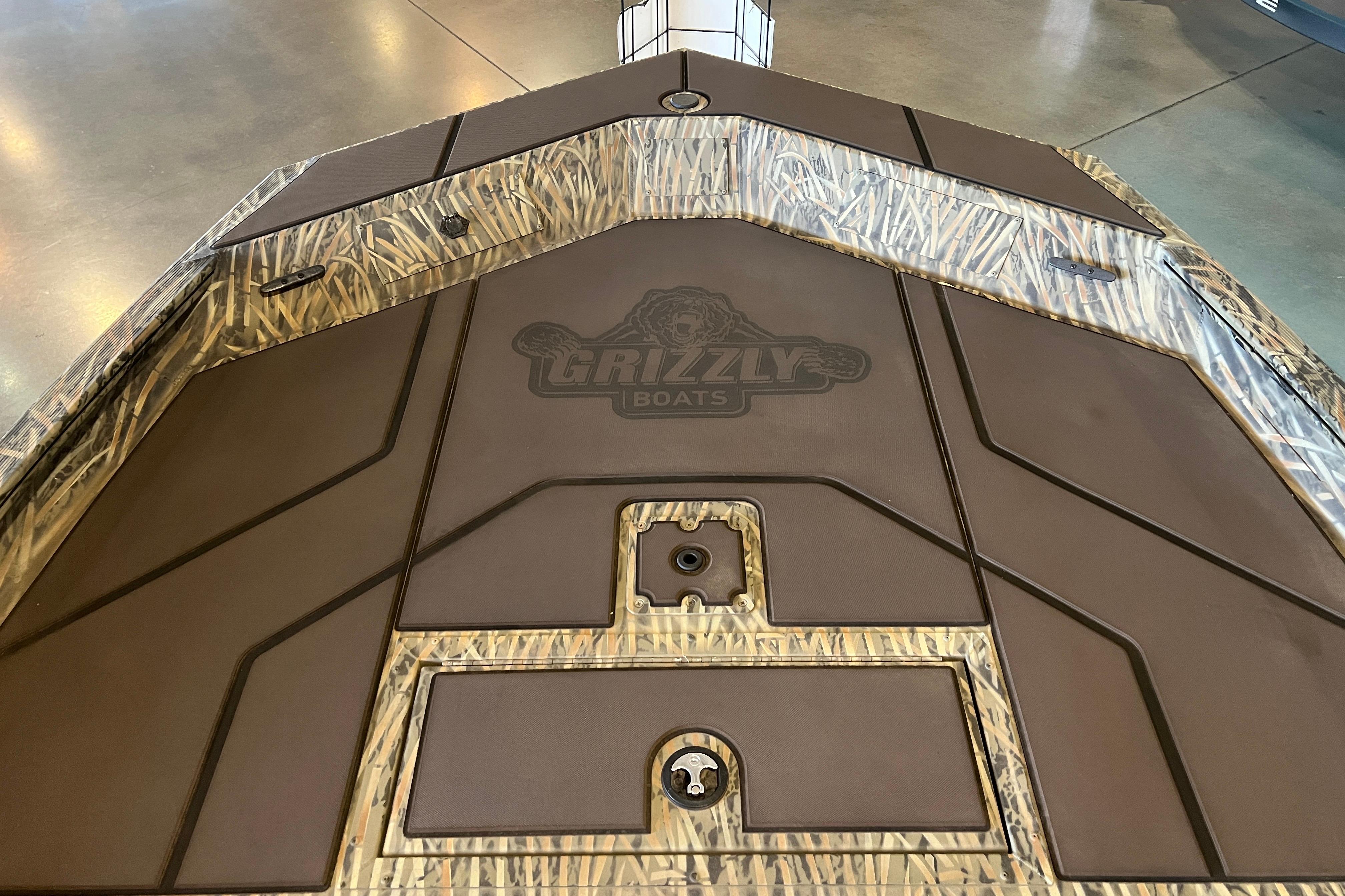 2026 Tracker Grizzly 1860 CC boat deck with camo pattern and logo.