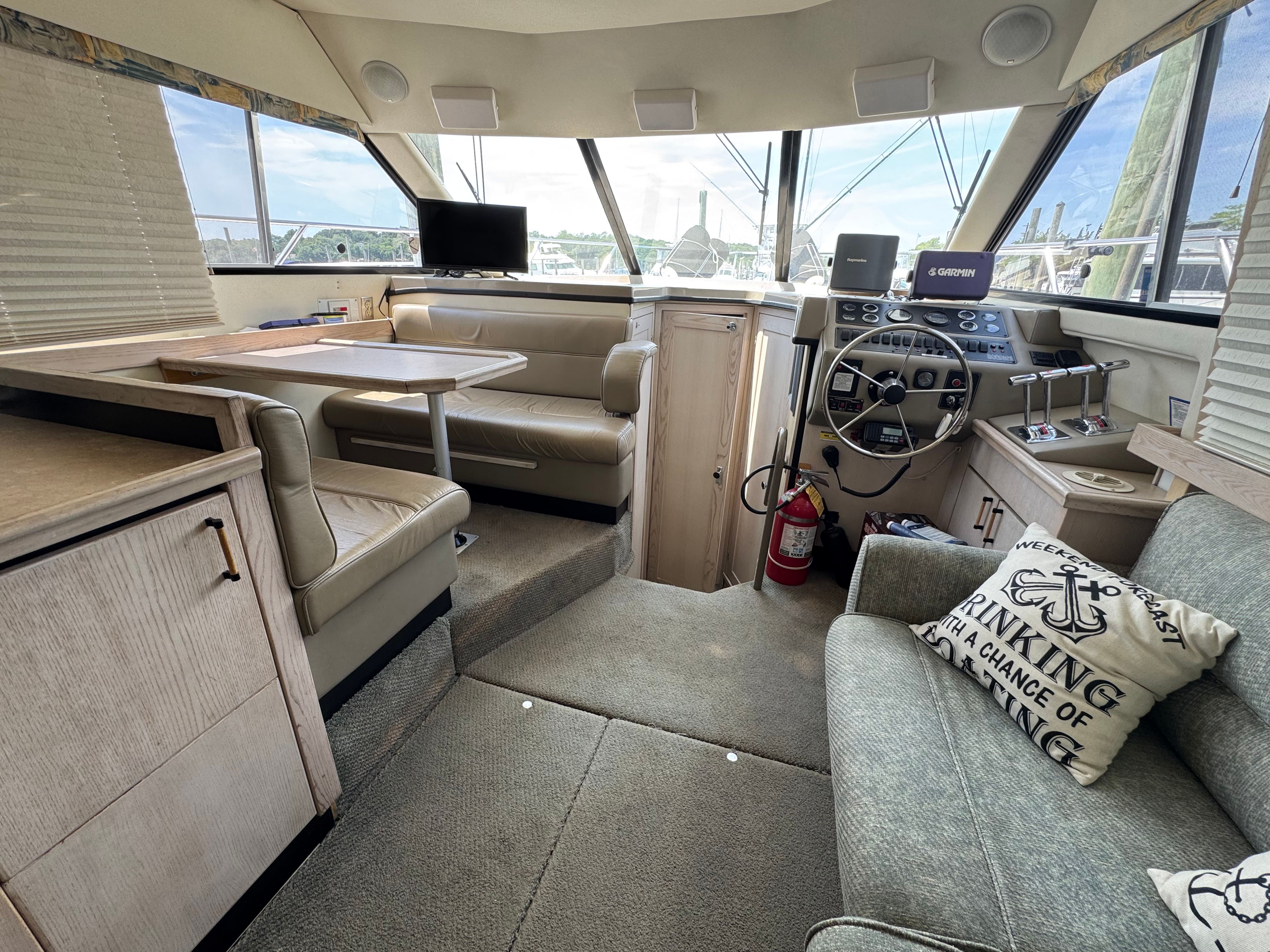 Interior of 1996 Bayliner 3587 yacht with helm and seating area.