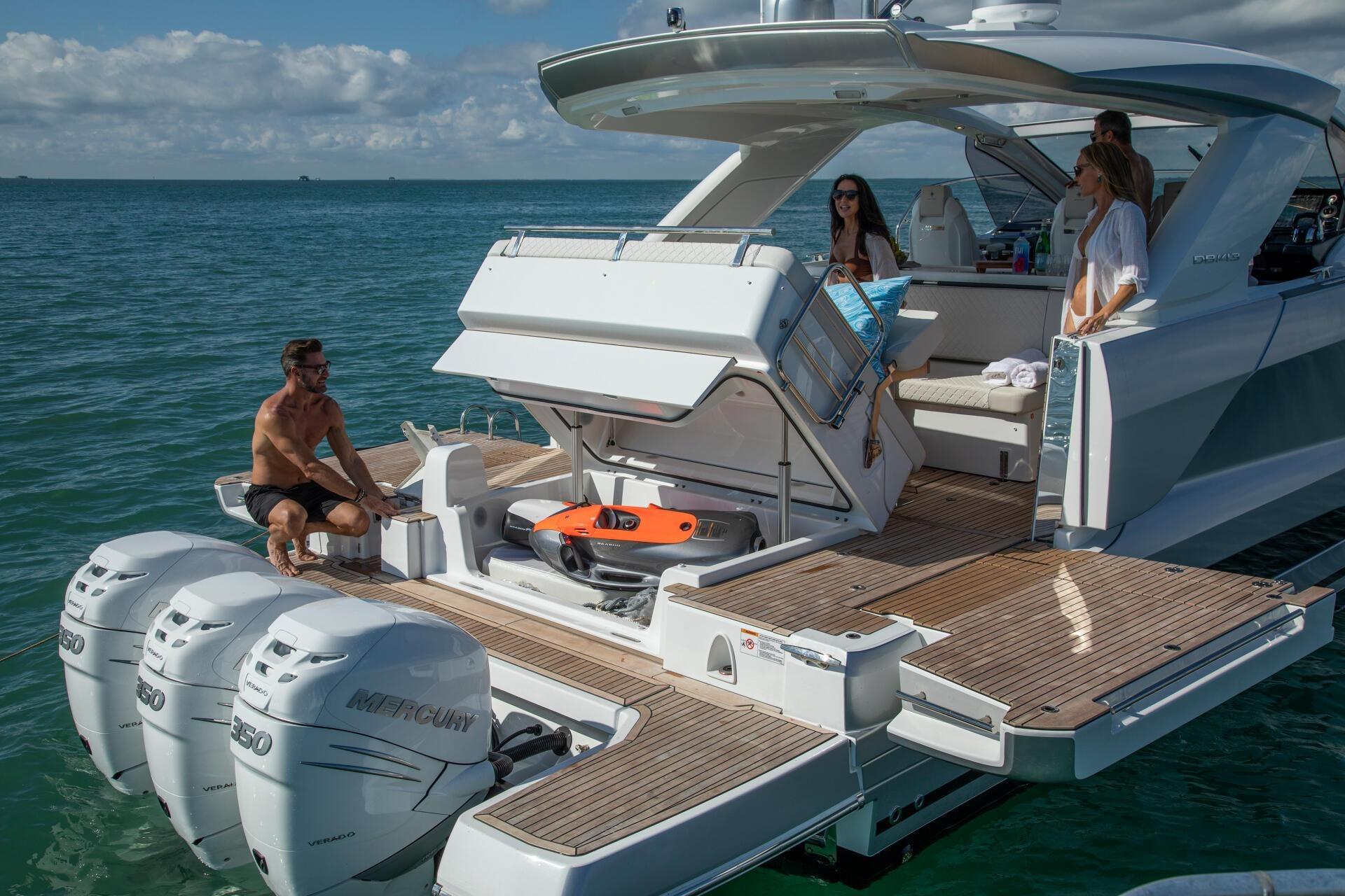2027 Jeanneau DB/43 OB yacht with people enjoying the deck and ocean view.