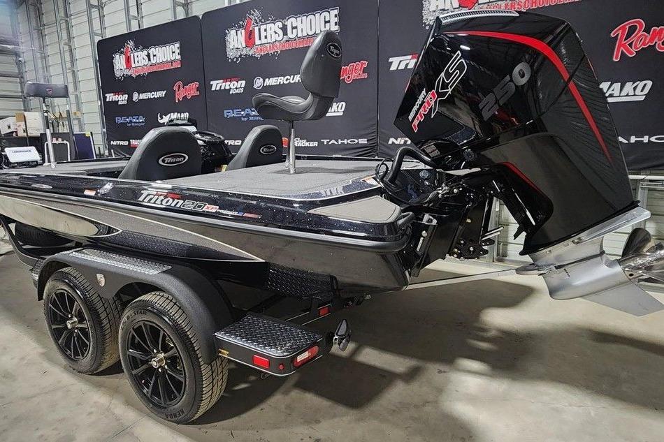 2026 Triton 20XP Patriot boat with powerful engine, showcased indoors.
