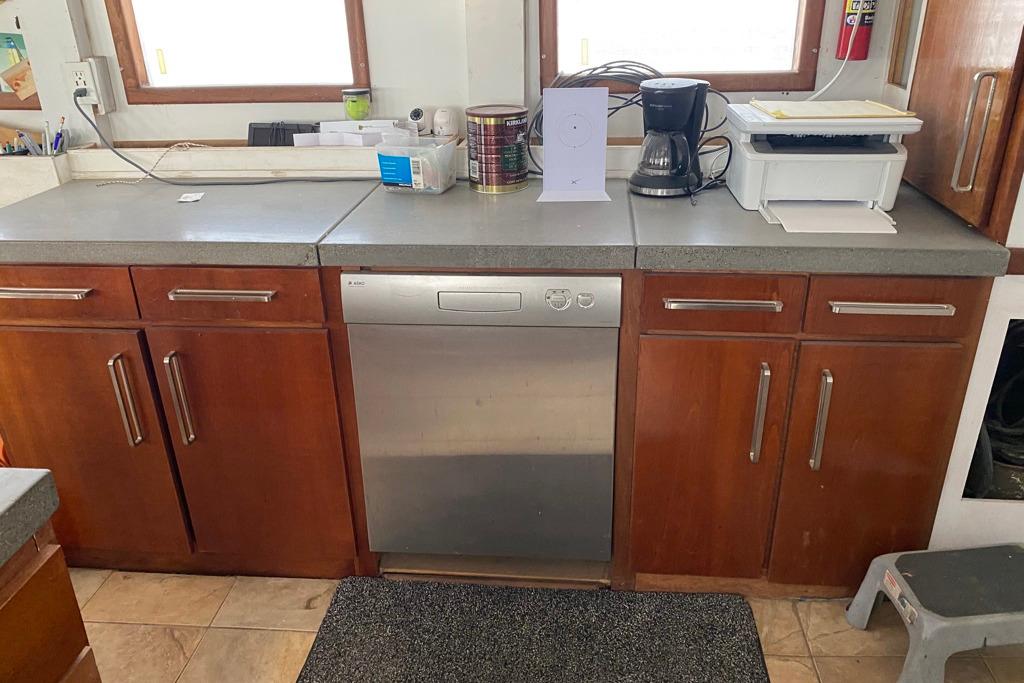 1979 Shrimper Conversion Trawler kitchen with wooden cabinets and modern appliances.