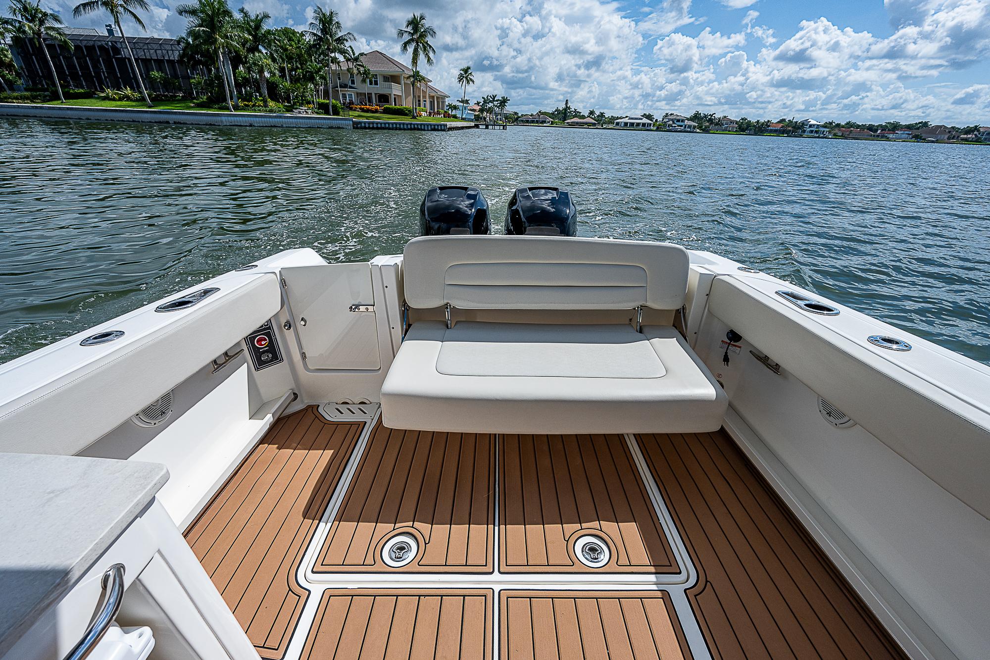 2018 Boston Whaler 270 Vantage boat interior with seating, on a sunny day by the water.