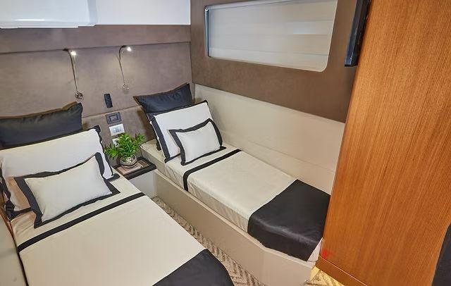 Luxurious twin cabin interior in Schaefer 660 yacht, 2025 model, with modern decor and bedding.