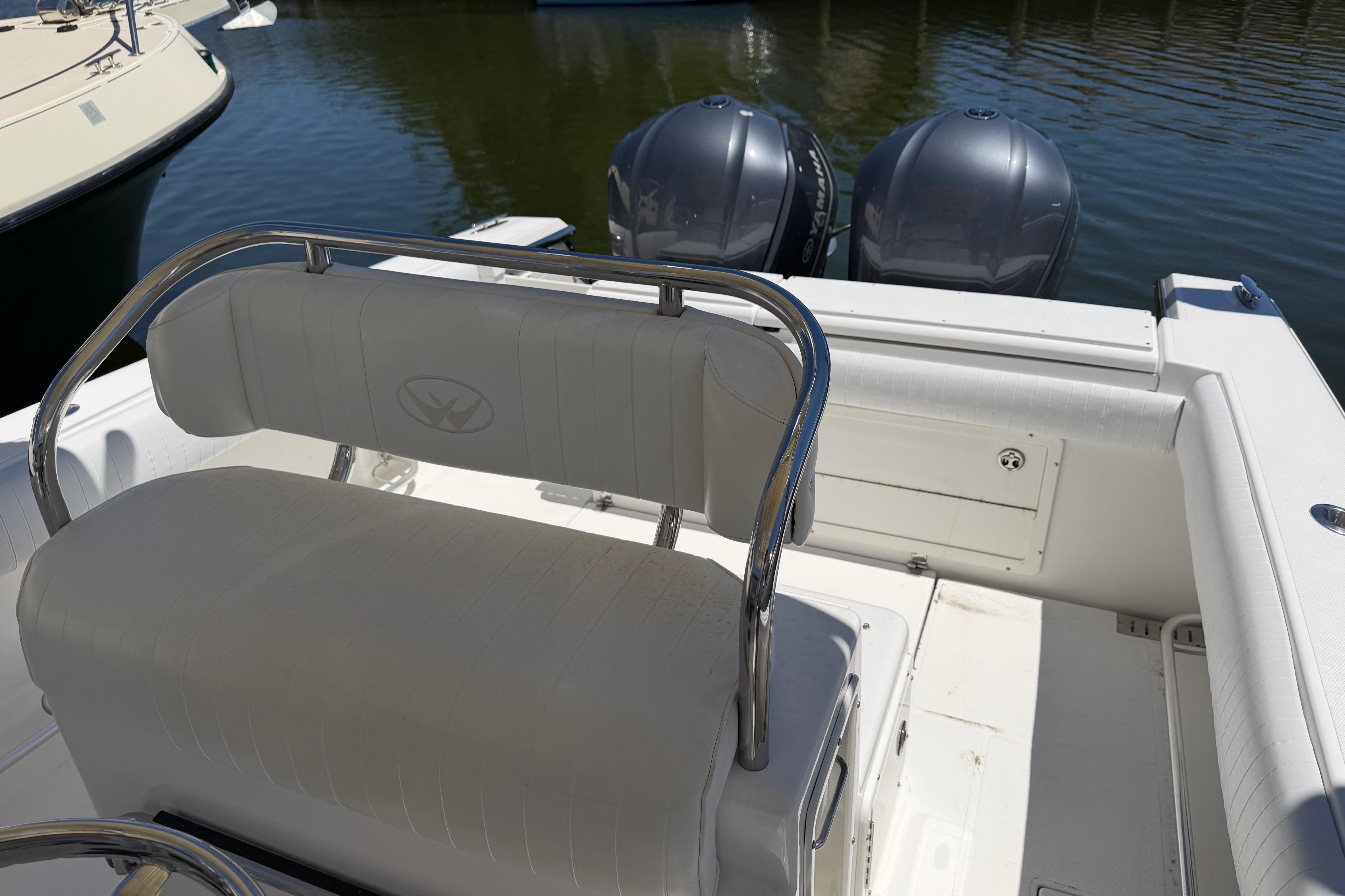 2006 Southport 26 Center Console boat with dual engines, docked on calm water.