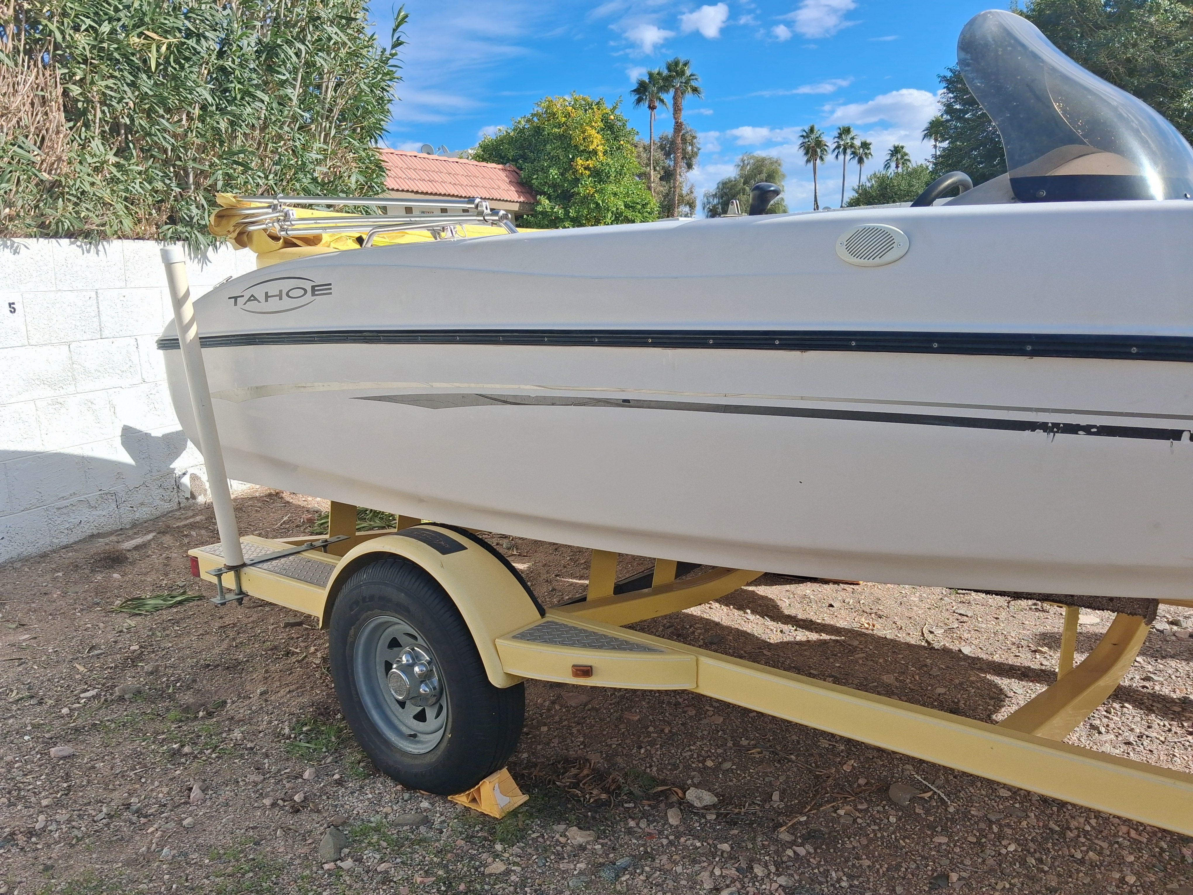 2004 Tracker Tahoe boat on yellow trailer, sunny day.