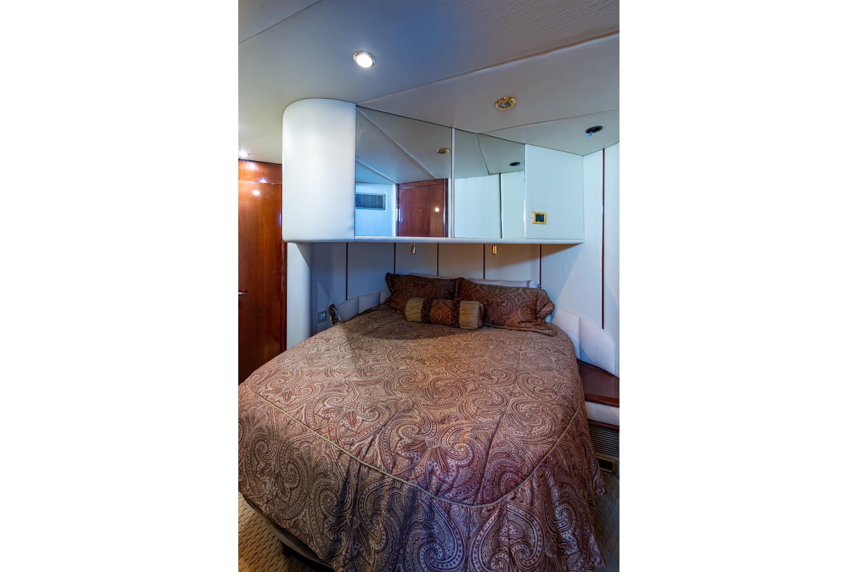 Luxurious bedroom interior on 2000 Fairline Squadron 52 yacht with elegant bedding.