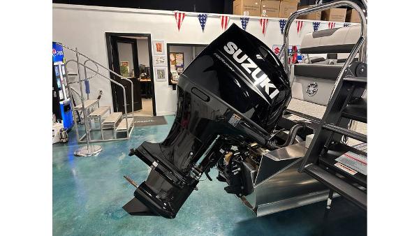 2025 Tahoe Pontoon Cascade Cruise with Suzuki outboard motor in showroom.
