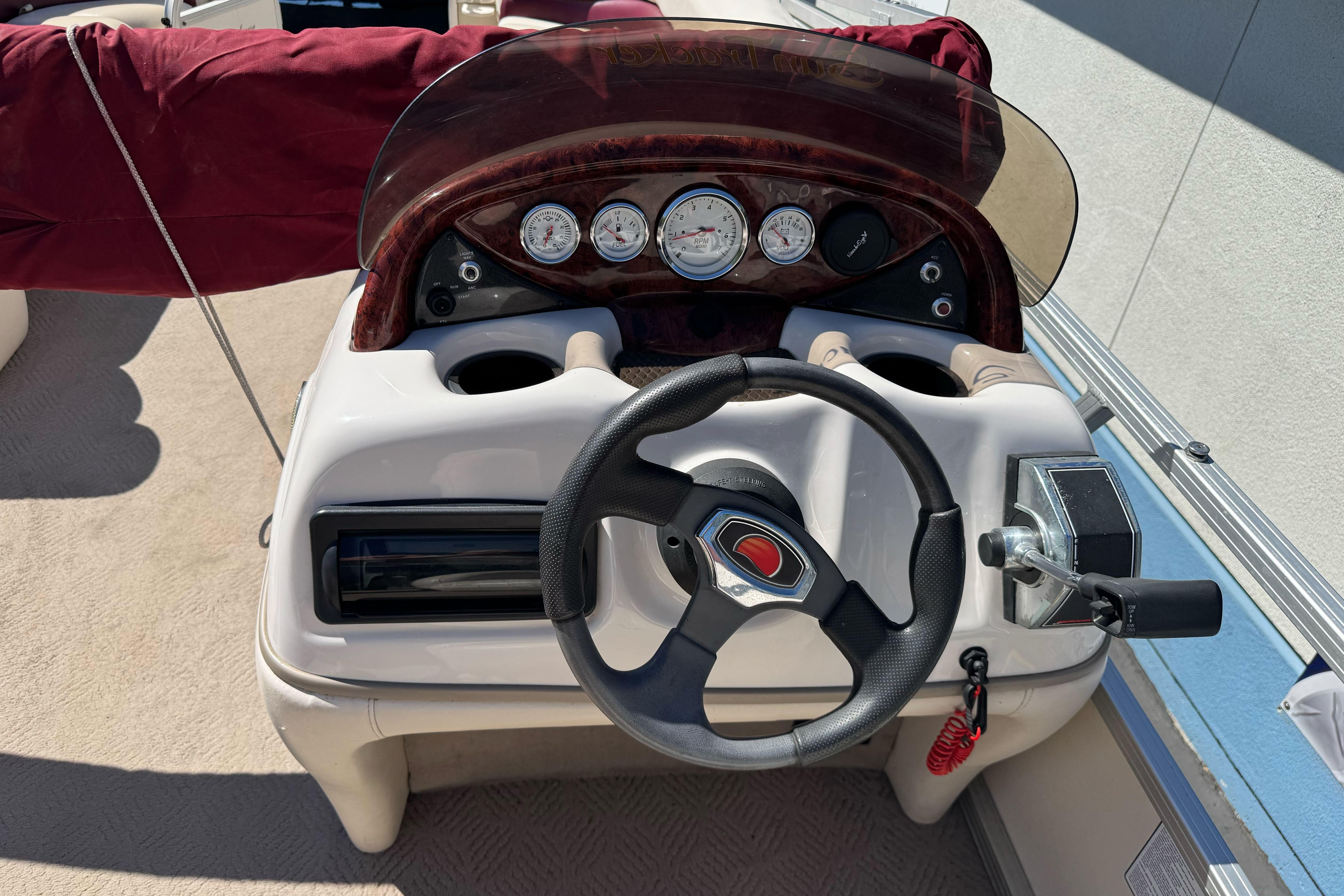 Steering console of a 2011 Sun Tracker Party Barge 21 pontoon boat.