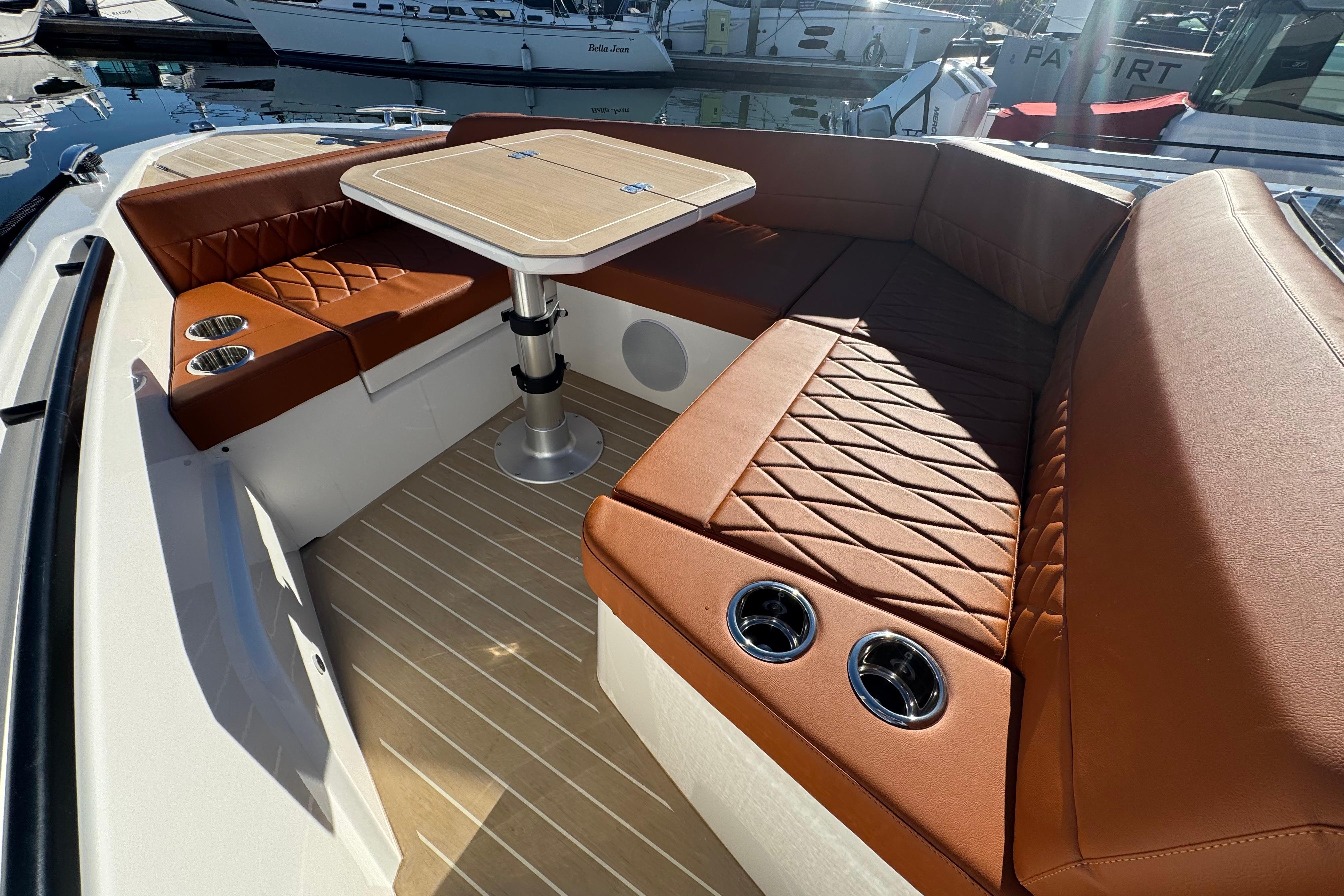 Luxurious seating area on the 2026 Saxdor 400 GTC boat with elegant brown upholstery.